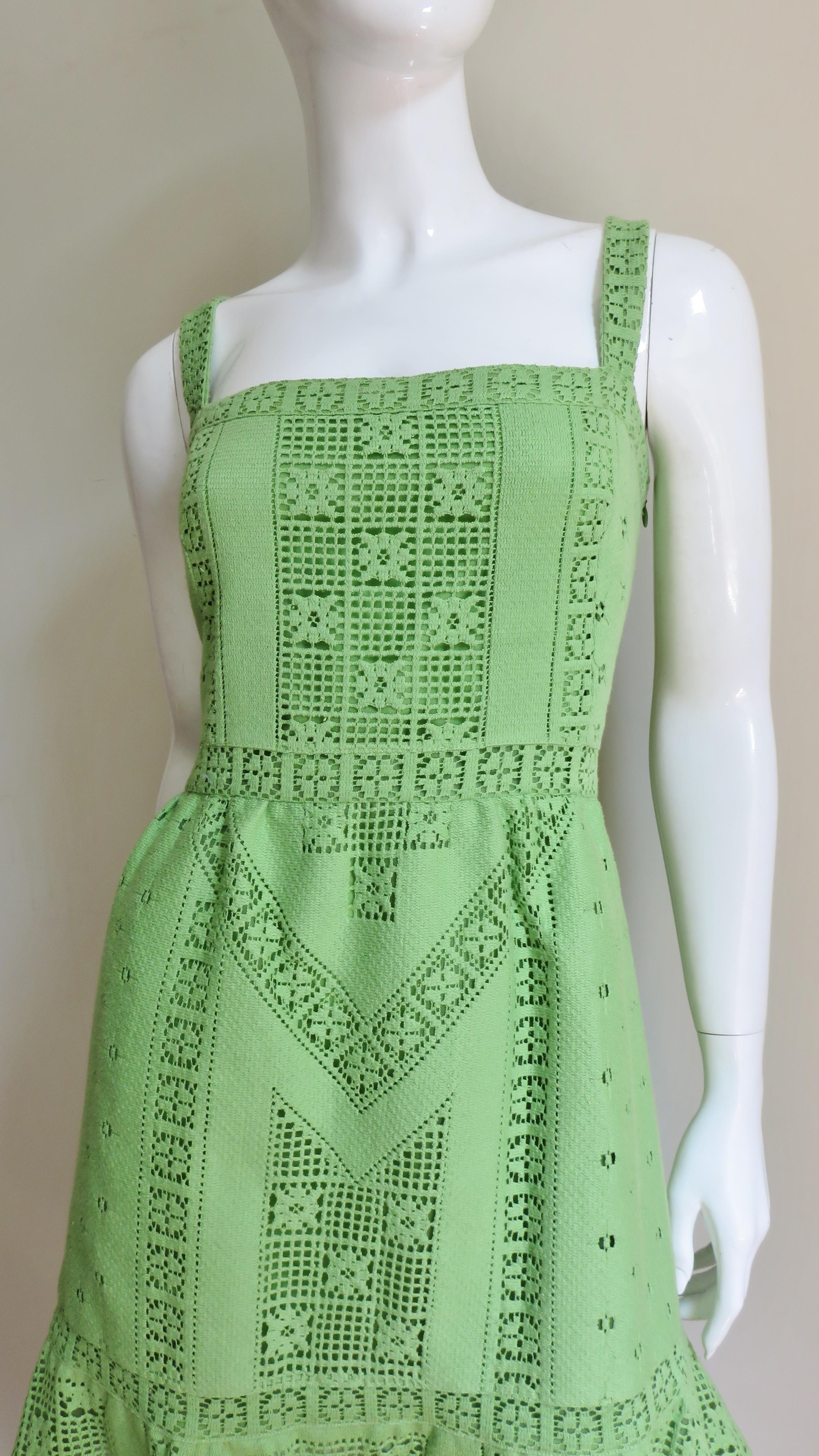 A beautiful apple green Guipure lace dress in an intricate flower and geometric motif from Valentino.  It has a semi fitted bodice with 1