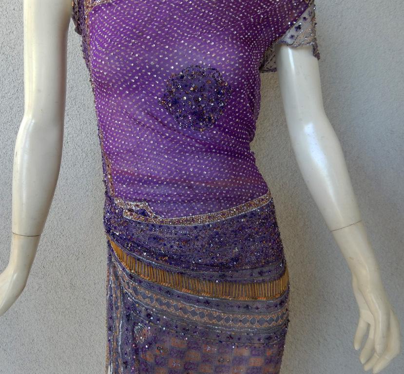 Fall 2003 designed by Valentino Garavani.  Rare, beautifully hand beaded and few produced.    Fashioned in shades of purple silk chiffon with skirt in a checkered pattern.  Entire dress is overlaid exquisitely in signature Valentino Garavani hand