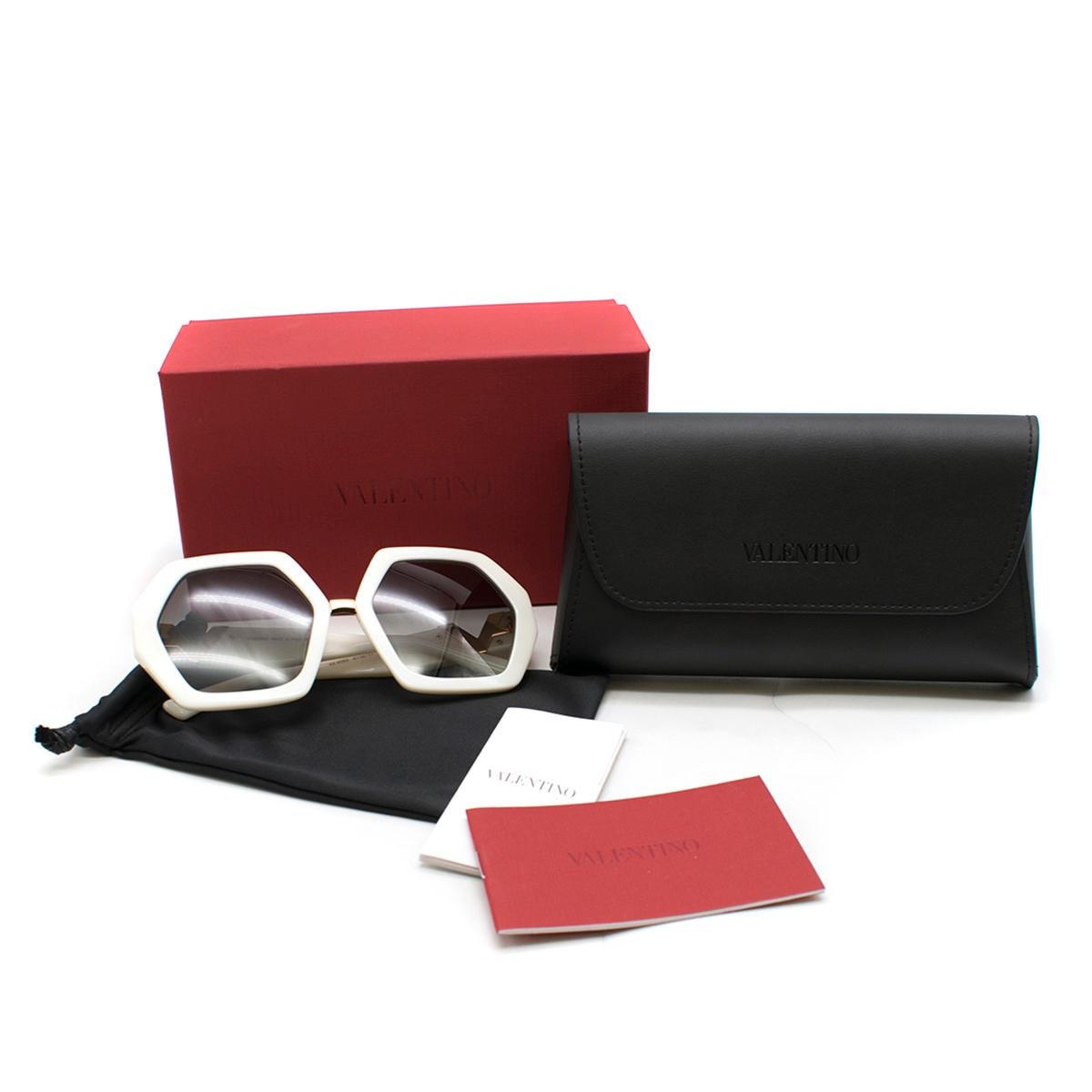 Valentino white hexagon-frame acetate sunglasses 

- Off-white, acetate
- Oversized hexagon frame
- Gradient black tinted lenses 
- Gold-tone metal nose bridge 
- Matching arms, gold-tone metal V cutout temple plaque, Rockstud tip feature 
- Comes