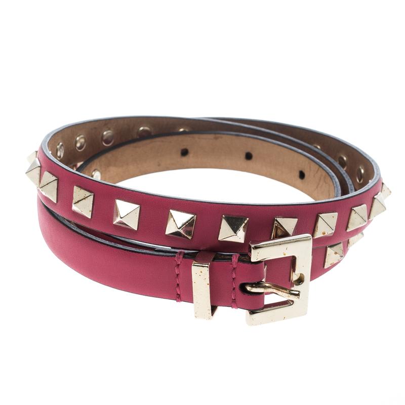 Complete any ensemble with a touch of luxurious fashion by flaunting this beauty of a belt from Valentino. It is crafted from hot pink leather and detailed with pyramid studs and a silver-tone pin buckle. The belt will look great with high waist