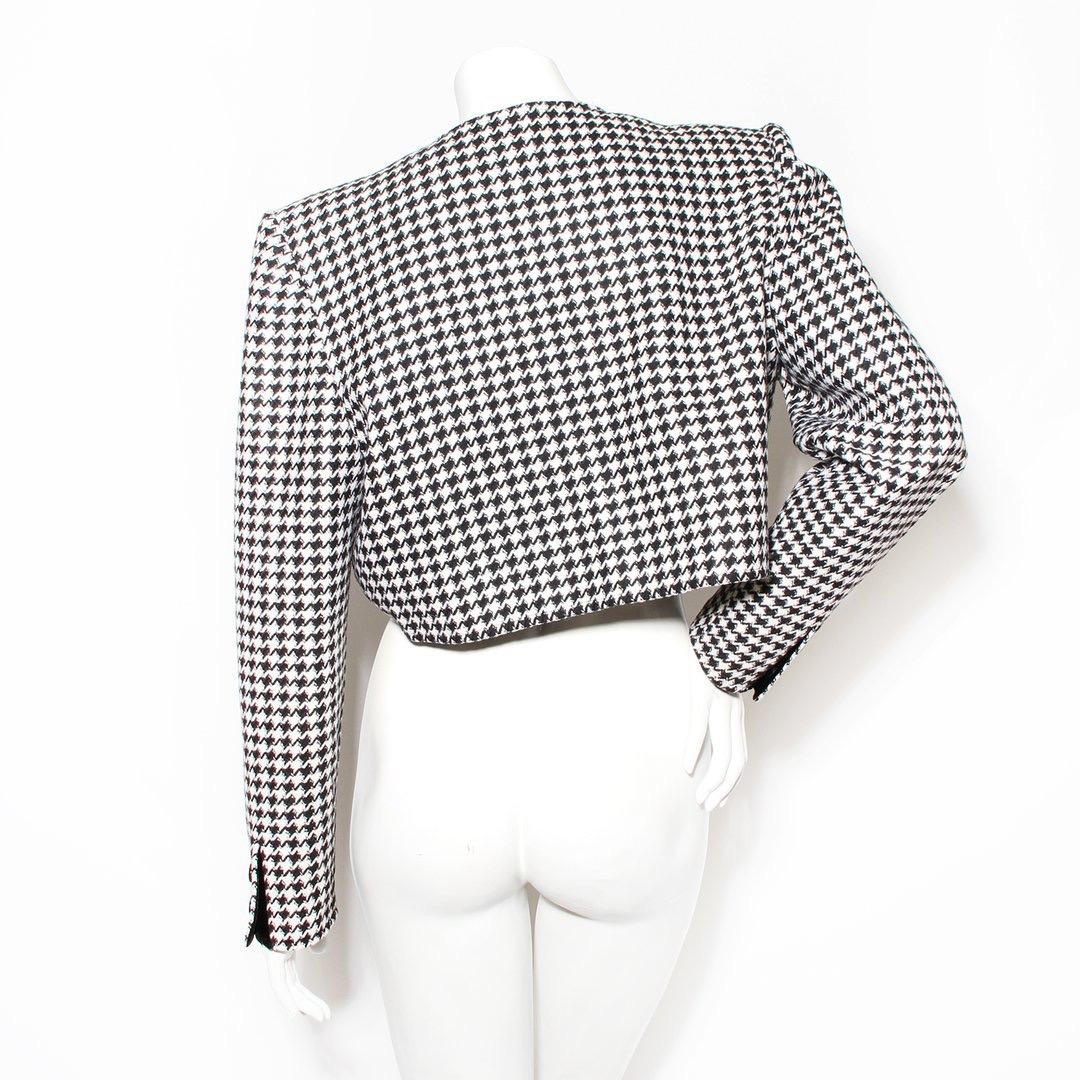 Houndstooth crop jacket by Valentino Boutique
Vintage 
Black and white 
Houndstooth pattern 
Faux button front details 
Zip front closure 
Shoulder pads 
Button cuff closure 
Velvet interior trim 
Long sleeve
Made in Italy
Condition: Excellent