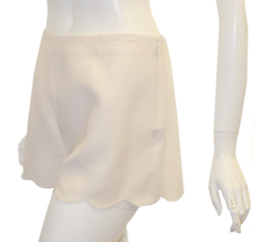 Valentino ivory crepe shorts with scalloped hem include hidden zipper and hook side fastening, for closure.  Unlined.  Excellent condition.  Made in Italy.