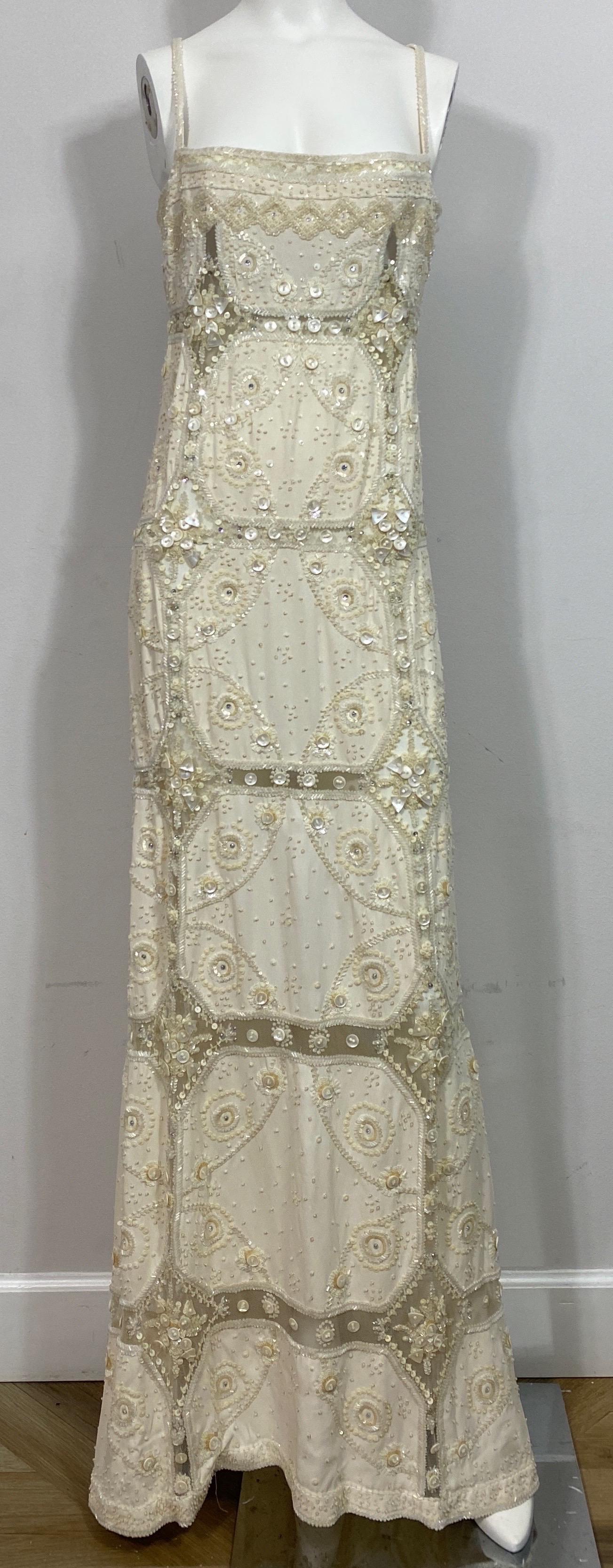 Valentino Ivory Heavily Embellished Beaded Silk and Mesh Gown - Size 12  This Valentino masterpiece will turn heads as the gown is heavily beaded throughout the silk and mesh areas in sequins of all different sizes, bugle beads, mabe pearl pieces in