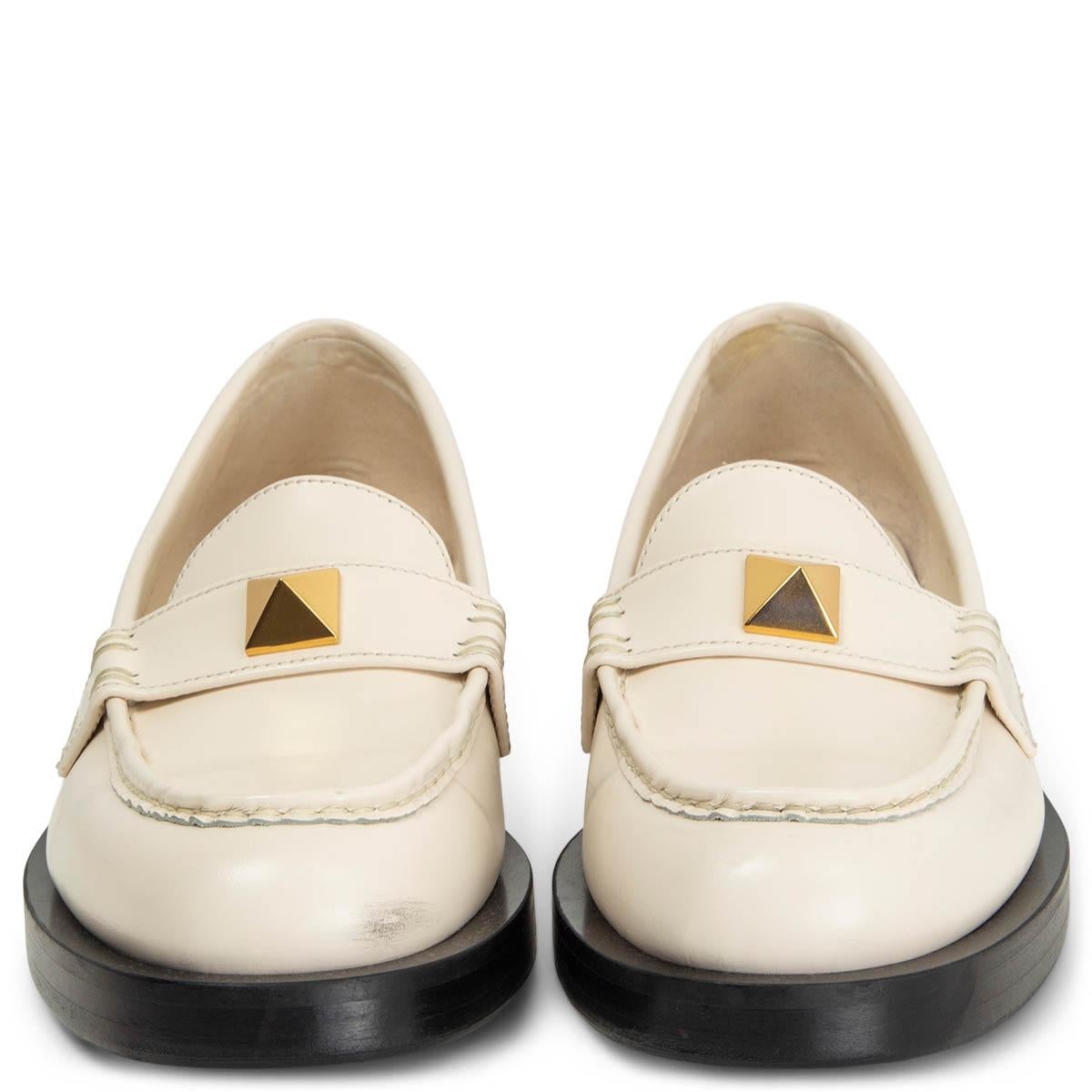 100% authentic Valentino Garavani Roman Stud loafer in ivory brushed calfskin. 18x18 mm maxi stud with an antique-brass finish and antique-brass finish maxi studs on the heel. Have been worn and are in excellent condition. Rubber sole got added.