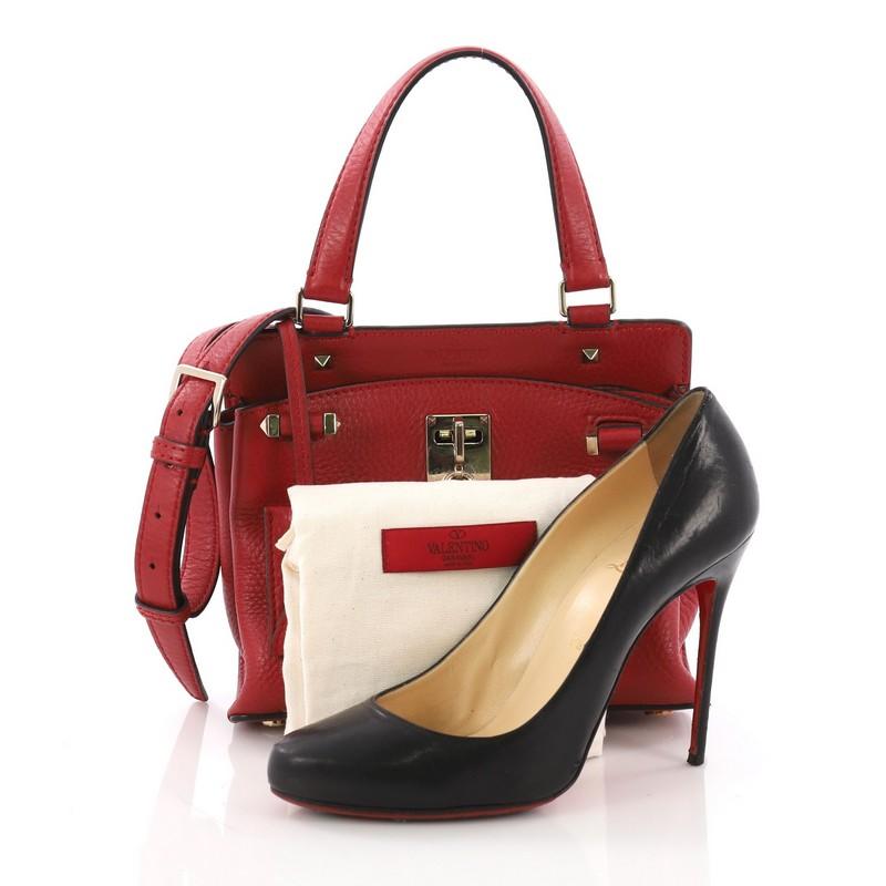 This Valentino Joy Lock Top Handle Bag Leather Small, crafted from red leather, features a leather top handle, grommet accents, and gold-tone hardware. Its turn-lock closure opens to a beige fabric interior with a side slip pocket. **Note: Shoe