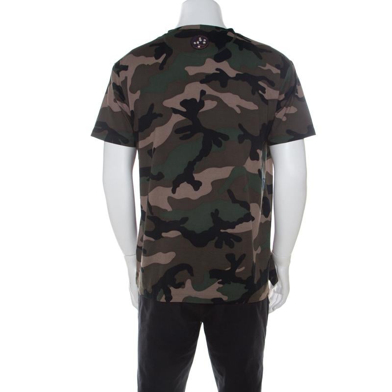 This t-shirt from Valentino adds that extra panache to your look. This stylish green t-shirt features a camouflage print all over with military appliques on the chest. Made of blended fabric, this finely crafted t-shirt can be worn with a pair of