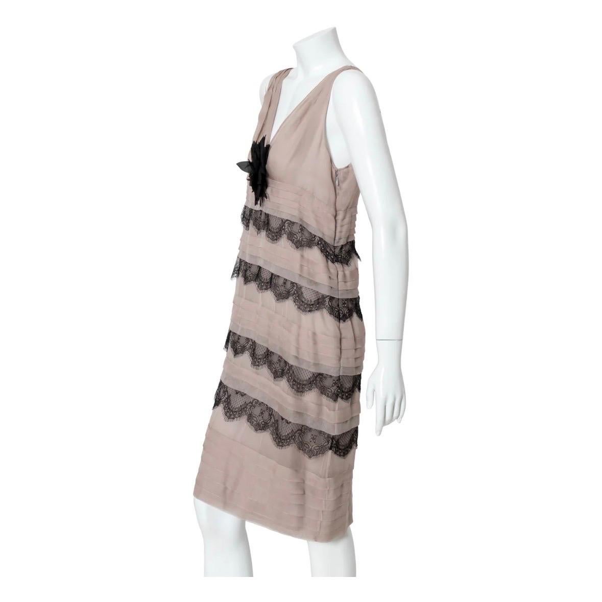 Lace chiffon sheath dress by Valentino
2008 Collection
Sleeveless
Deep v-neckline
Feather floral detail
Horizontal pleating
Tiered black lace
Semi-sheer
Above knee-length
Sheath silhouette
Dusty purple/lilac
Side zipper closure
Unlined
Made in