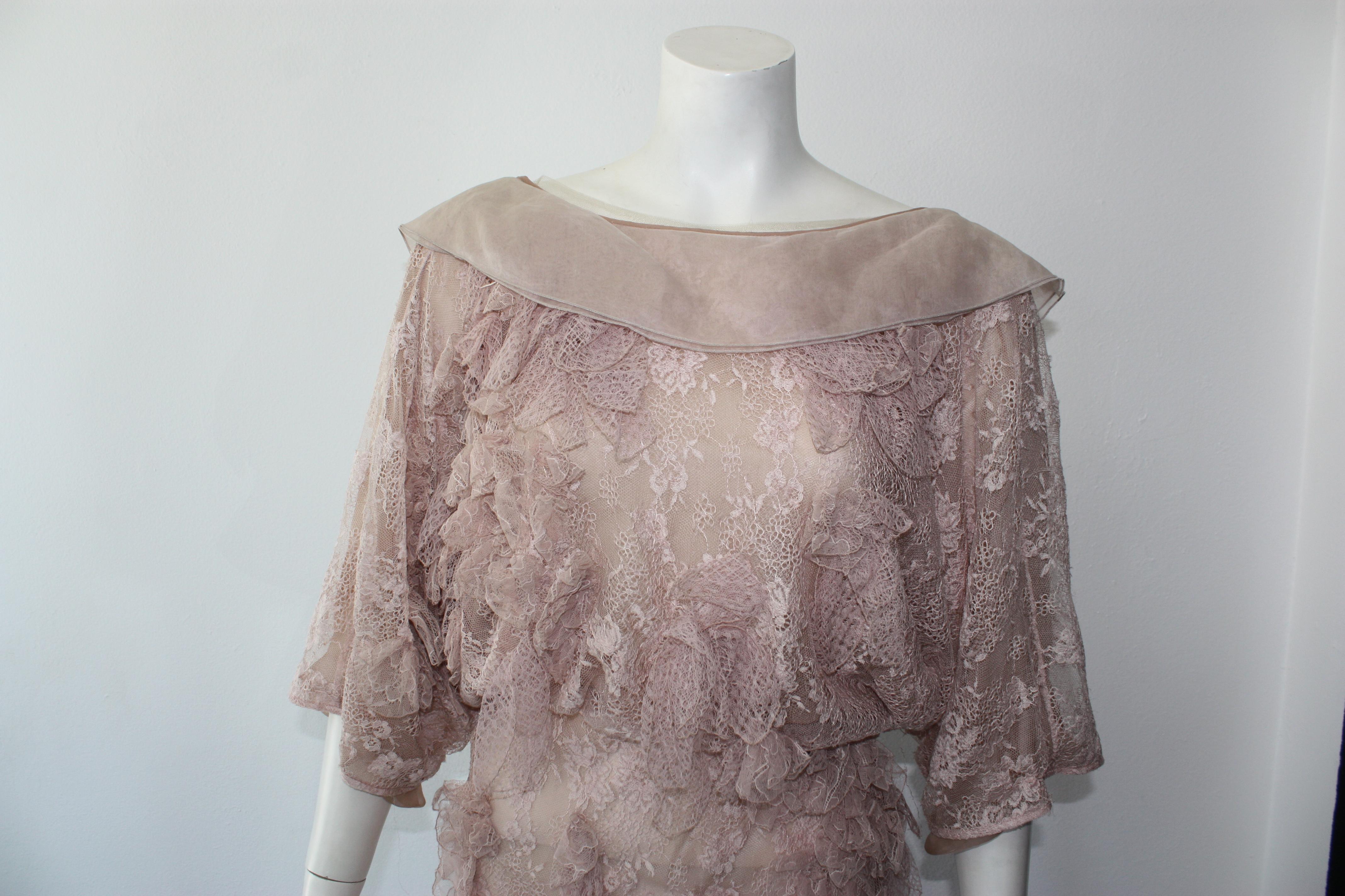 Valentino blush pink lace dress with lace applique throughout. Draped open back with crossover surplice skirt. Button snap closure.

New with tags, but minor snags throughout.
Size S
100% silk
