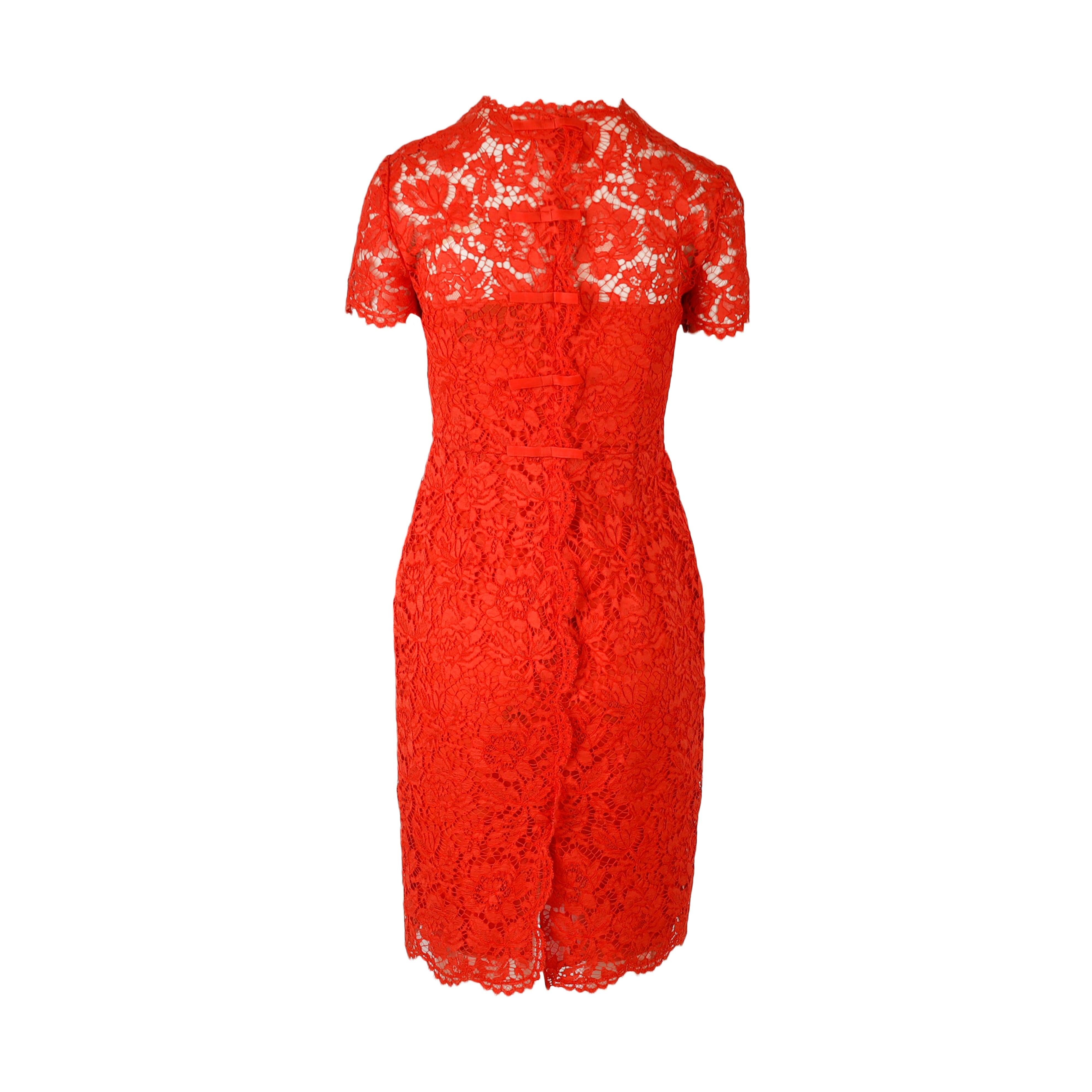 This Valentino Lace Midi Dress offers a slim contour and delicate embroidery for a classic, flattering look. Boasting short sleeves and a lined interior, this dress is further detailed by bows on the back closure and a small slit at the hem.
 
 