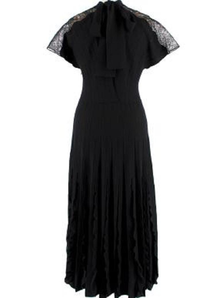 Valentino Lace Trimmed Black Stretch Knit Midi Dress

- Pussy bow detail at the neckline 
- Lace panel over the shoulders
- Sleeveless
- V neckline
- Double lining
- Accentuated waist
- Ruffles in the skirt
- Zip fastening at