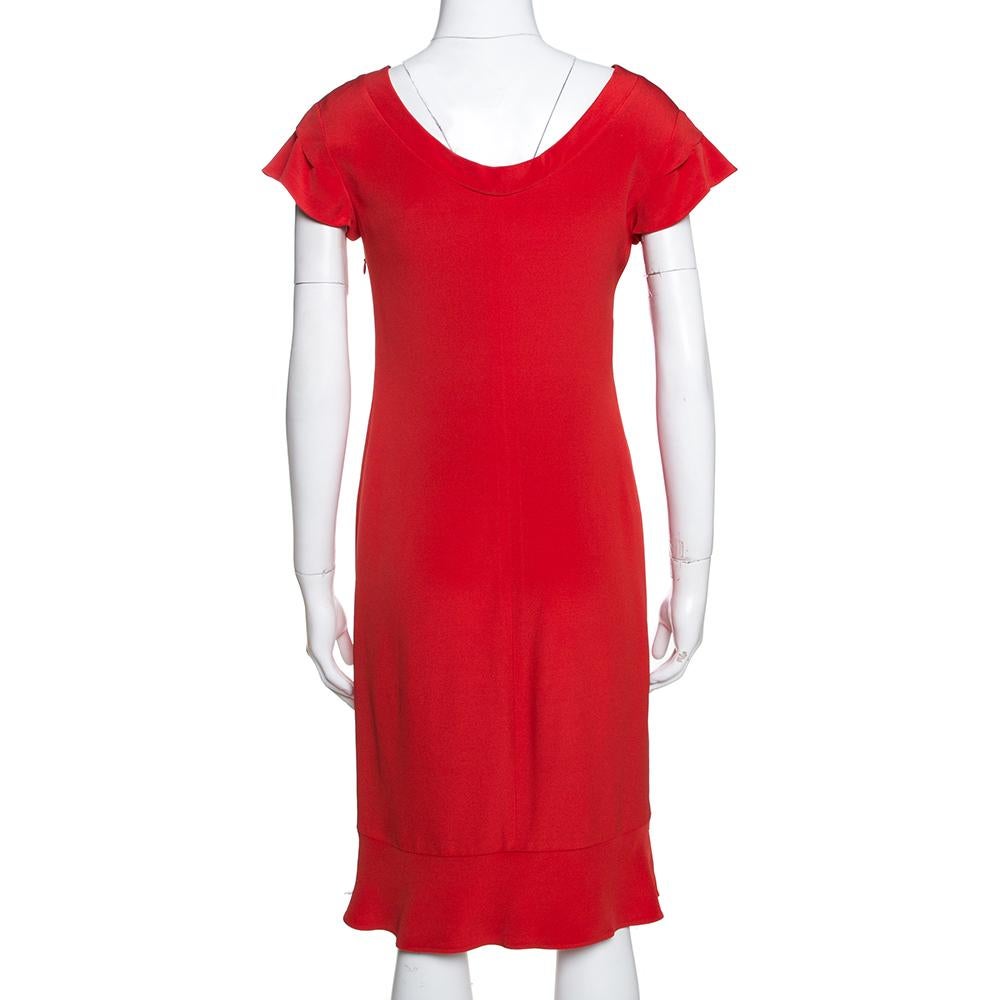 Beautifully tailored, this sheath dress comes from the iconic house of Valentino. It is a great pick for evenings and special occasions. it is crafted from quality materials and is lined with pure silk. It has a striking red hue, short sleeves,