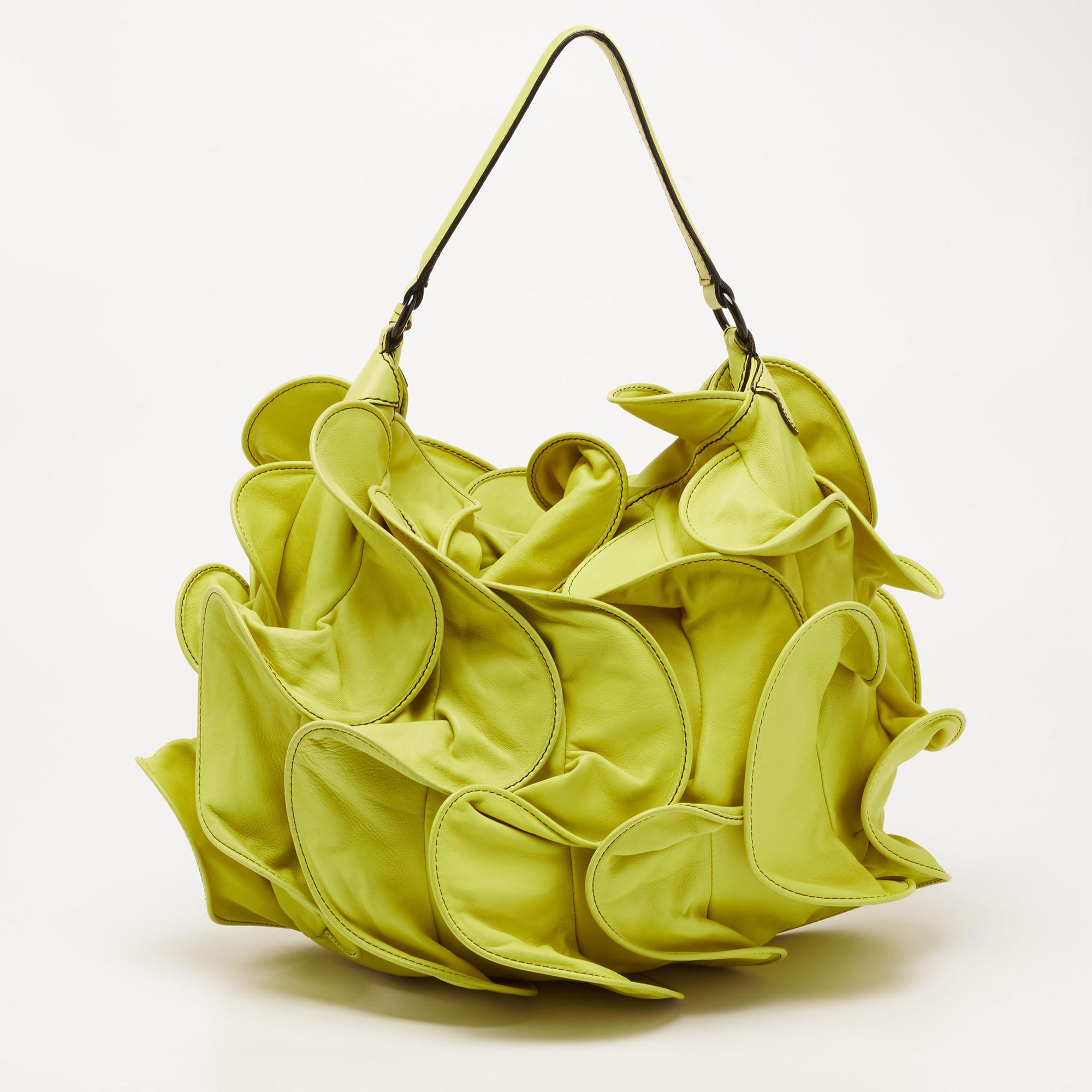 What's not to love in this hobo from Valentino! From its cheerful lemon-yellow shade to its ruffled exterior, this hobo is truly appealing and admirable. It is made from leather and highlighted with a 22 cm handle drop, black-tone fittings, and a