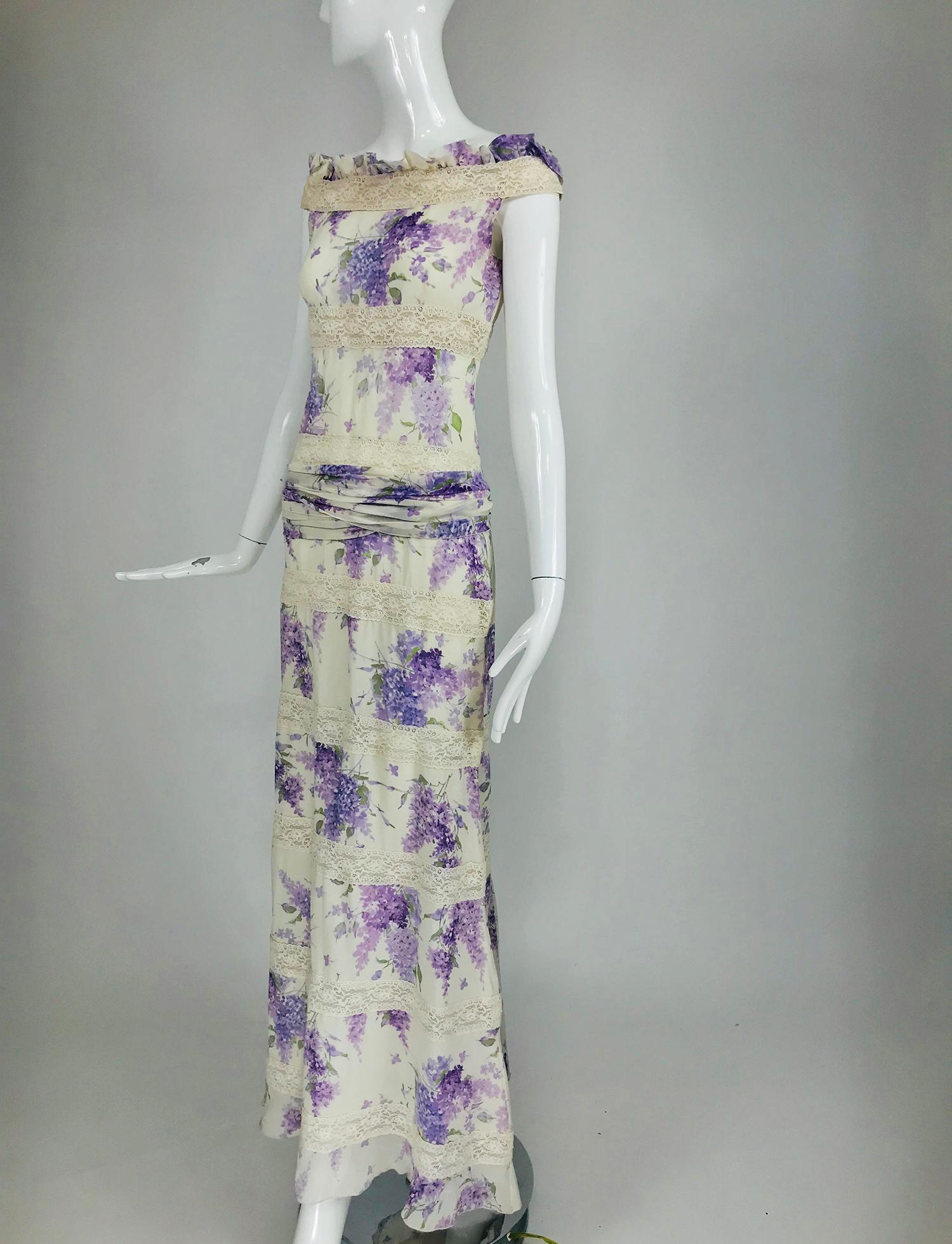 Valentino lilac print silk and lace maxi dress with very long ties at the lower waist back, we have wrapped them around the hip. This lovely dress rides the shoulder edge with a ruffle of silk and lace. The dress is done in wide alternating bands of