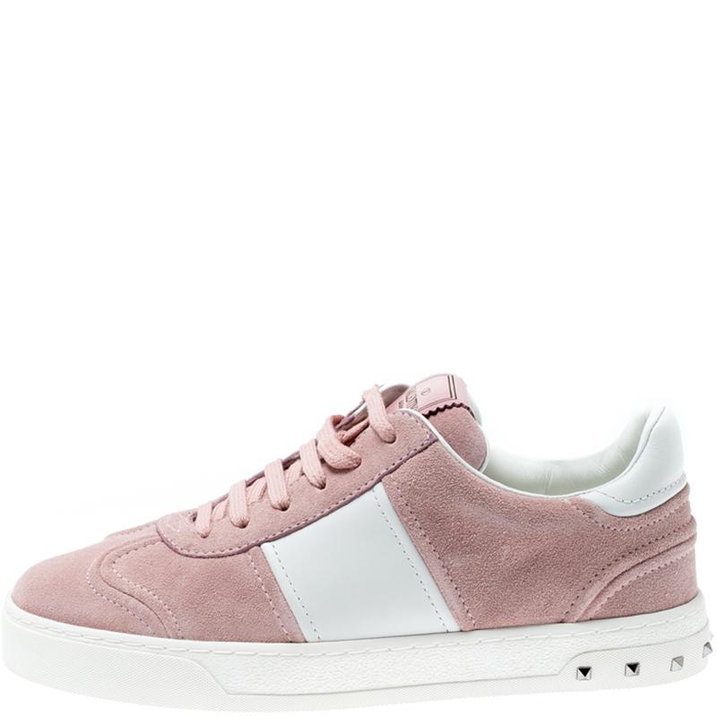 These Flycrew sneakers from the house of Valentino have been designed from Bianco suede and leather body. It comes with lace-ups and is set on a subtly raised sole. It is detailed with the signature pyramid studs from the house. Style your with