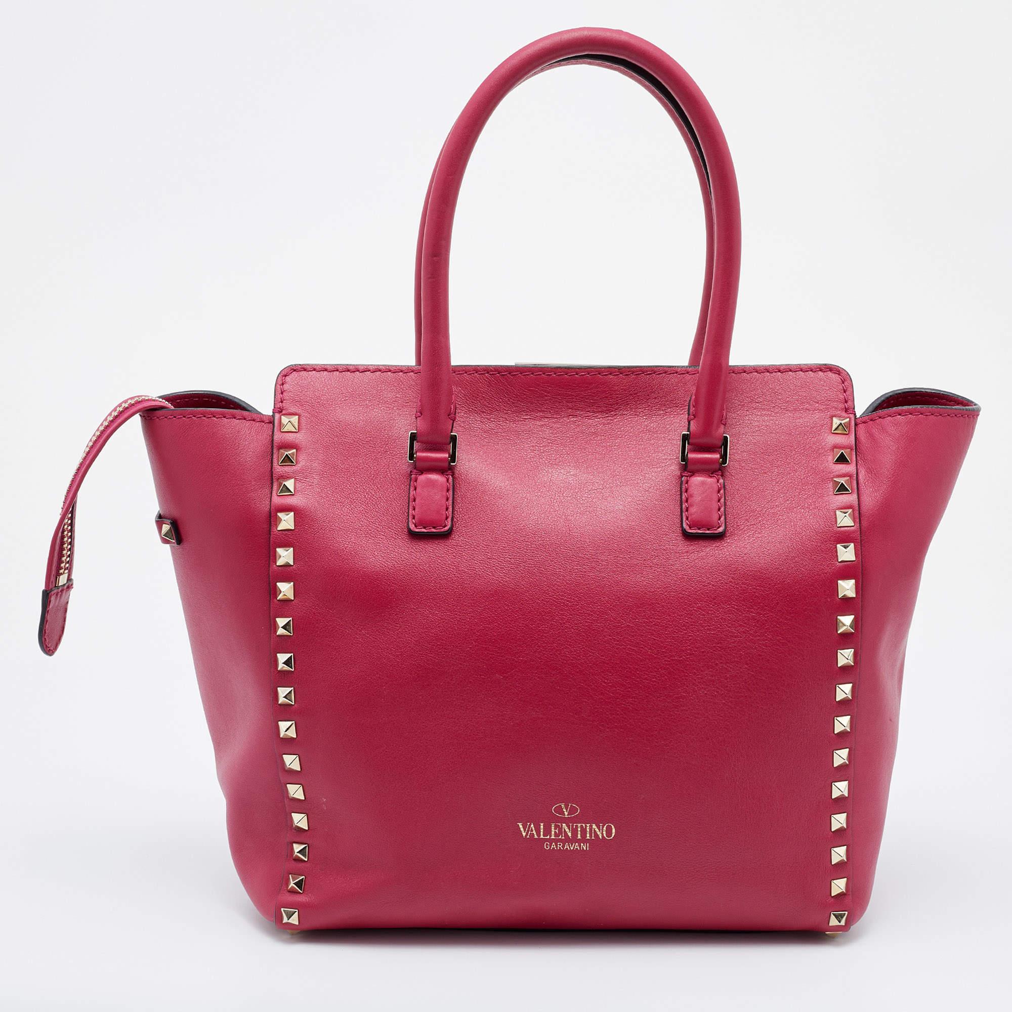 Luxury Italian fashion house Valentino is famed for its classic designs infused with its own signature modern edge, and Rockstud details beautifully outline this Trapeze tote. Crafted from leather, it features dual handles and a detachable shoulder