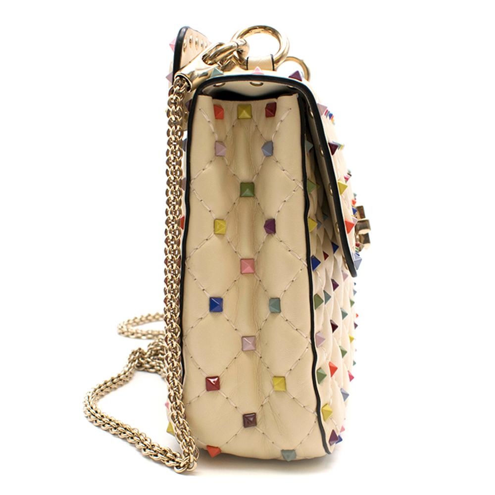 Rockstud Spike Small Quilted-Leather Shoulder Bag in Ivory Multi

Valentino's ivory quilted-leather Rock-stud Spike Pyramid studs in a rainbow of hues 
Pale gold-tone metal twist-Lock closure, 
Red interior. 
Top handle and chain shoulder strap.