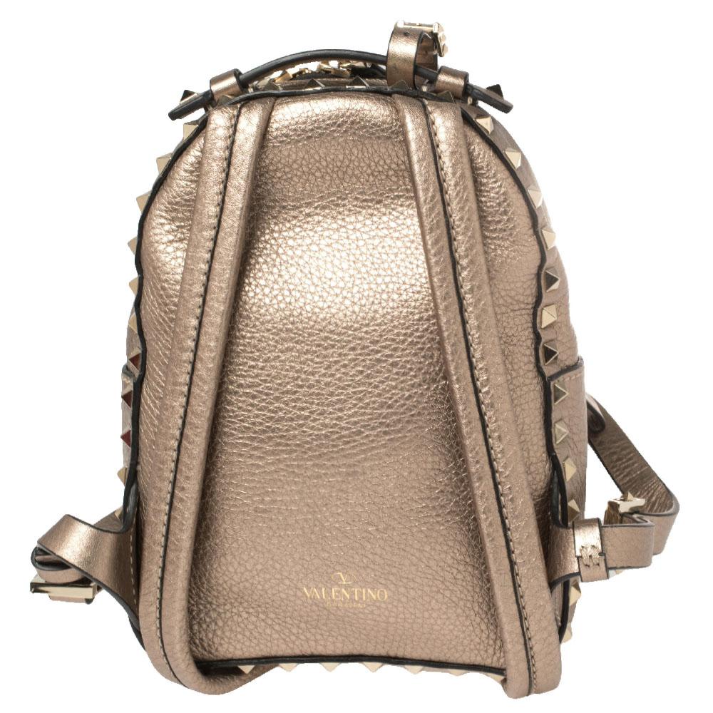 Get set to carry your everyday essentials with luxe ease using this Mini Rockstud backpack by Valentino. Crafted using pebbled leather, the backpack features a handy top handle, two adjustable shoulder straps, and a pocket on the front. The Rockstud