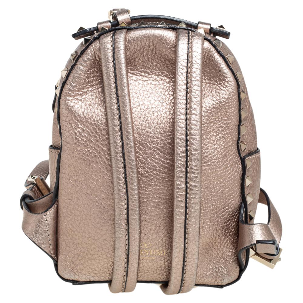 Get set to carry your everyday essentials with luxe ease using this Mini Rockstud backpack by Valentino. Crafted using pebbled leather, the backpack features a handy top handle, two adjustable shoulder straps, and a pocket on the front. The Rockstud