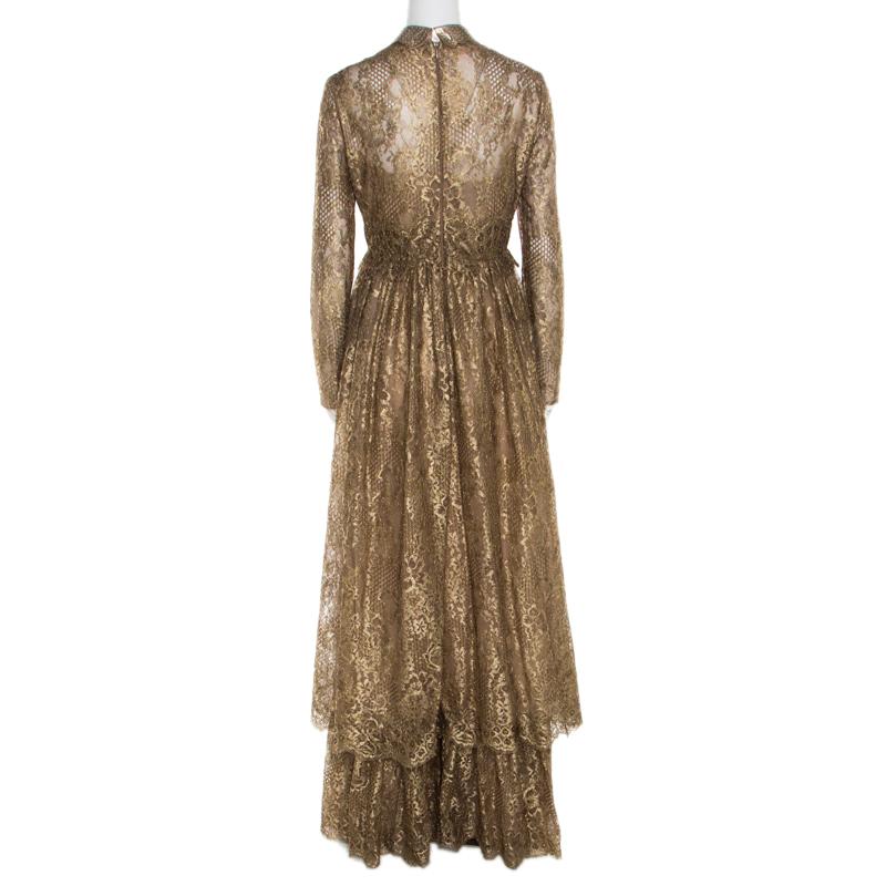 Feel royal in this exquisite gown from the house of Valentino. Ideal for grand nights, this metallic gold piece, designed with floral lace, a studded leather collar and tiered skirt, can be worn with open toe sandals.

Includes: The Luxury Closet