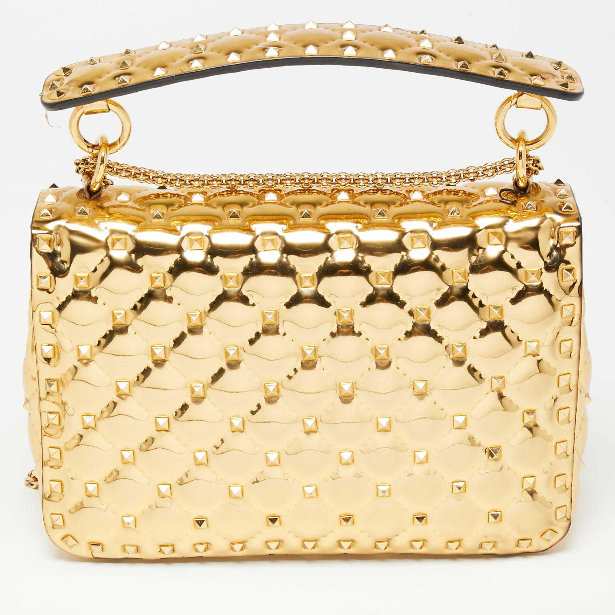 Let Valentino's fashion-forward aesthetic be the highlight of your look with this Rockstud Spike bag – note how the studs blend with the metallic gold patent leather. Crafted in Italy, it is perfectly shaped to easily house your everyday essentials