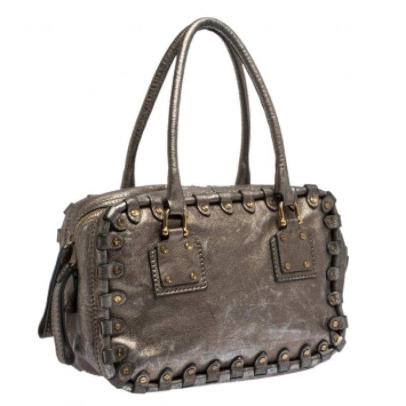 This satchel bag by Valentino will elevate all your outfits. Crafted in Italy, it is made from quality leather. It comes in a lovely metallic hue. It is styled with dual handles, stud detailing, double zip closure and gold-tone hardware. The bag