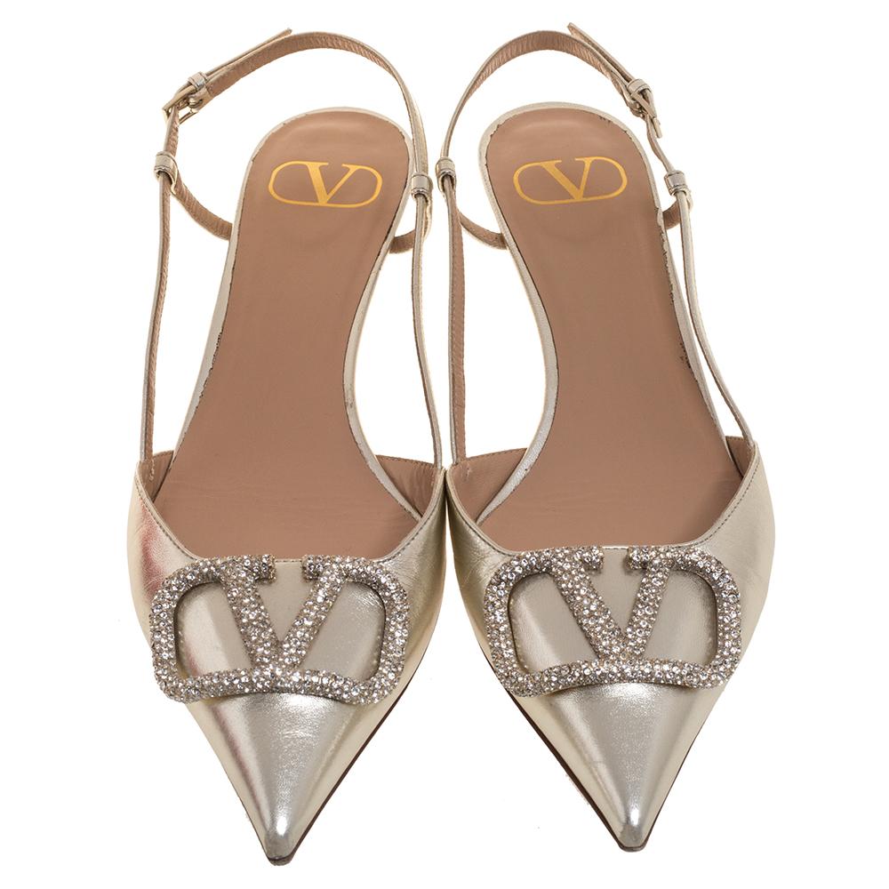 These stunning pumps showcase Valentino's feminine sensibilities and elegant aesthetics. Crafted in Italy from metallic leather, the pointed-toe silhouette is augmented by the VLogo Signature motifs encrusted with petite crystals exuding an opulent