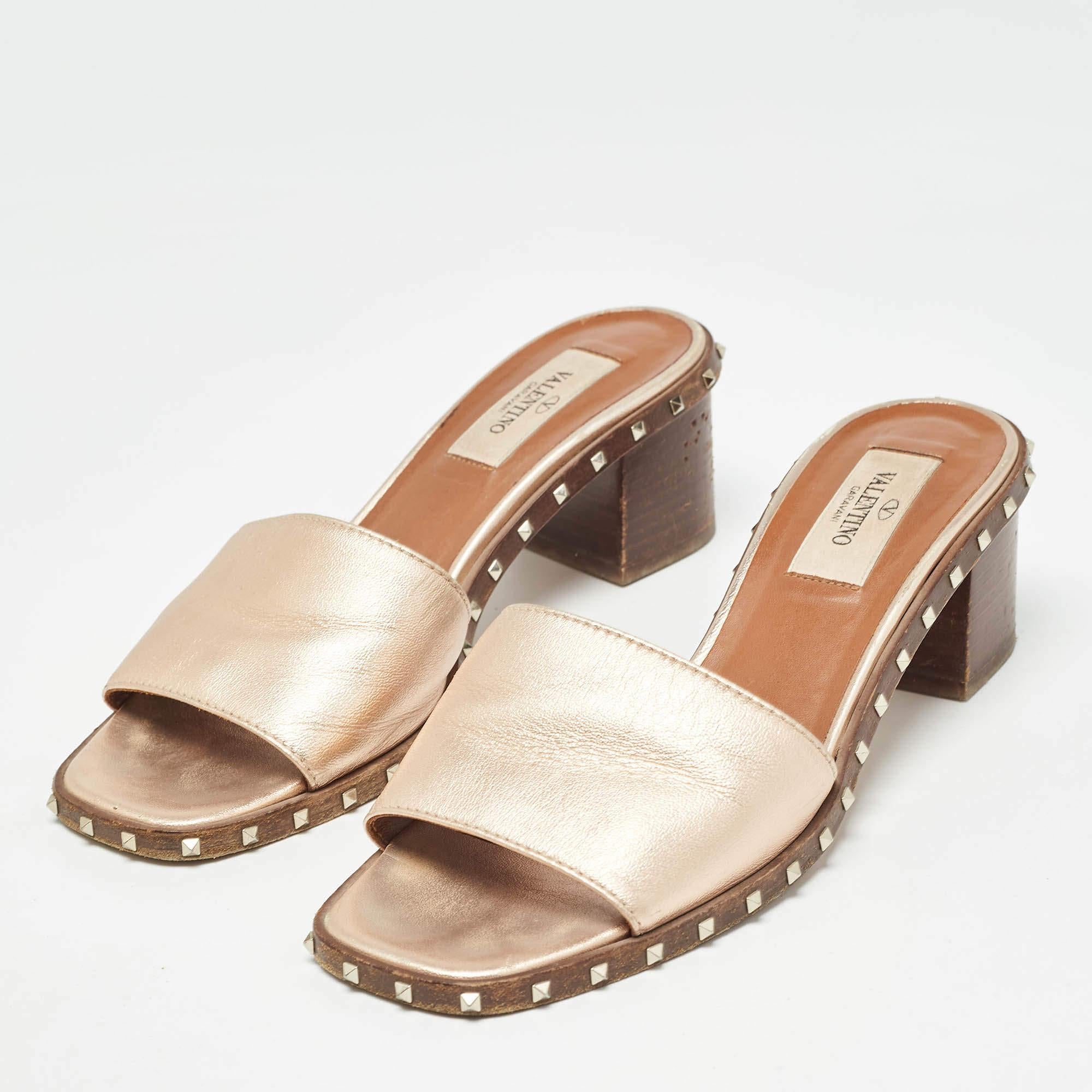 These metallic rose sandals from Valentino are crafted from leather. These sandals feature an open toe silhouette signature Rockstud detailing block heels and comfortable leather lined insoles. The vivid details deserve your attention and will add