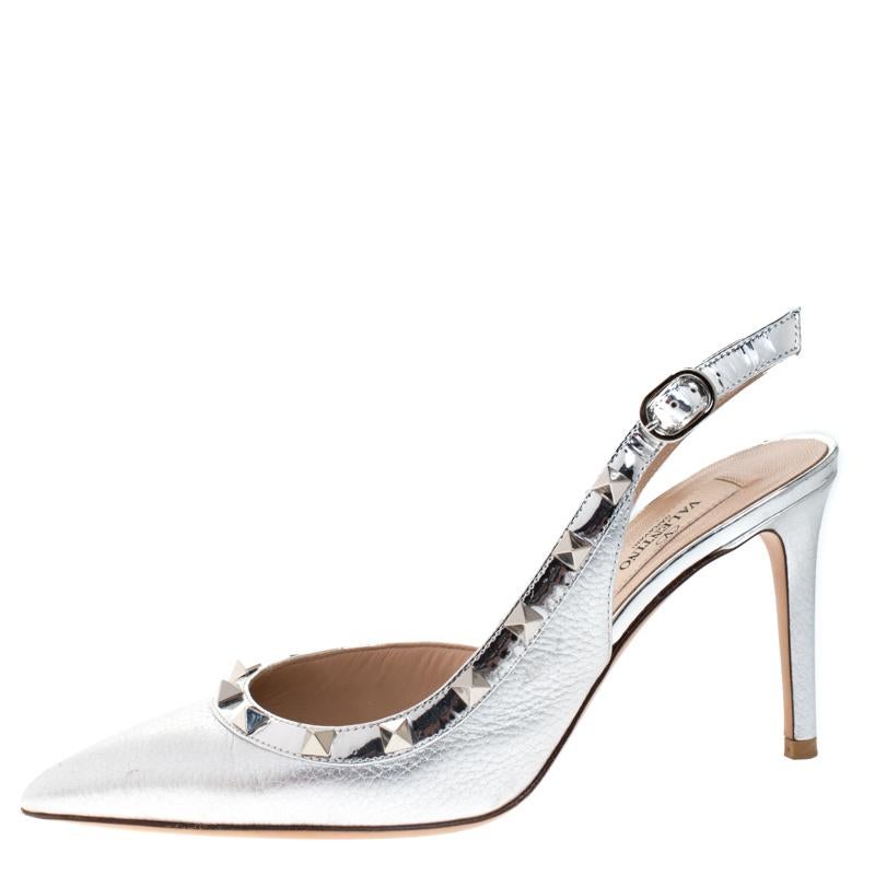 From the house of Valentino, these sandals are tastefully designed. The metallic silver sandals are crafted from leather and feature a D'orsay silhouette. They flaunt pointed toes and slingback straps with signature Rockstuds in silver-tone. They