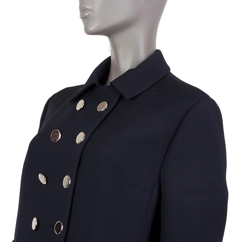 100% authentic Valentino military-style double-breasted coat in midnight blue wool (71%) and silk (29%). With flat collar, buttoned waistband, and two slit pockets on the sides. Closes with flat silver-tone buttons on the front. Lined in midnight