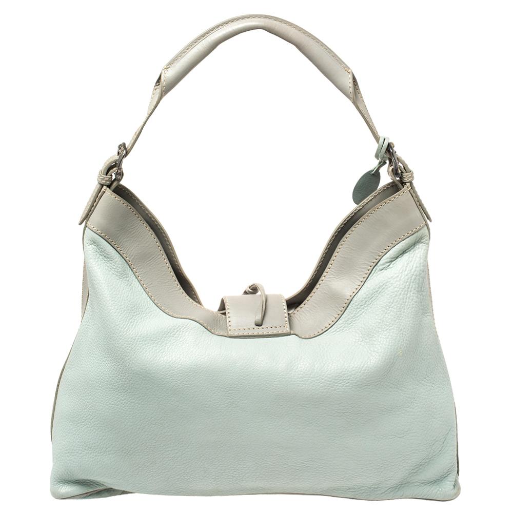 Minimal aesthetics, maximum appeal. This Valentino hobo is crafted in mint blue and grey leather, secured by a silver-tone metal motif, and lined with satin. Held by a single handle, the hobo is ideal for everyday use.

