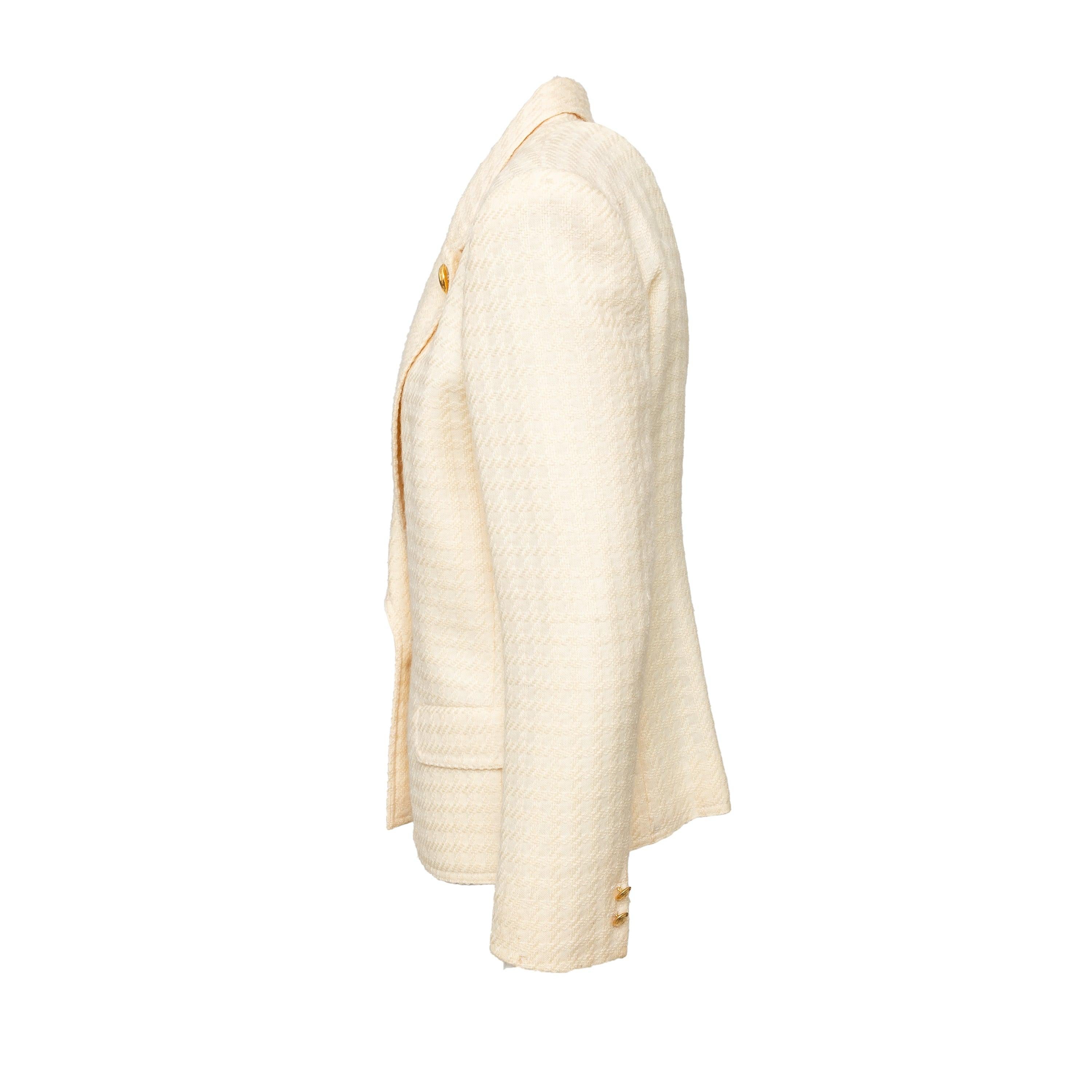This classic vintage wool jacket is from Valentino's Miss V label, featuring light shoulder pads that give it a beautiful structure. The gold buttons and low cut lapels add chic accents, while the textured fabric adds a touch of luxury. 
 Remarks:
