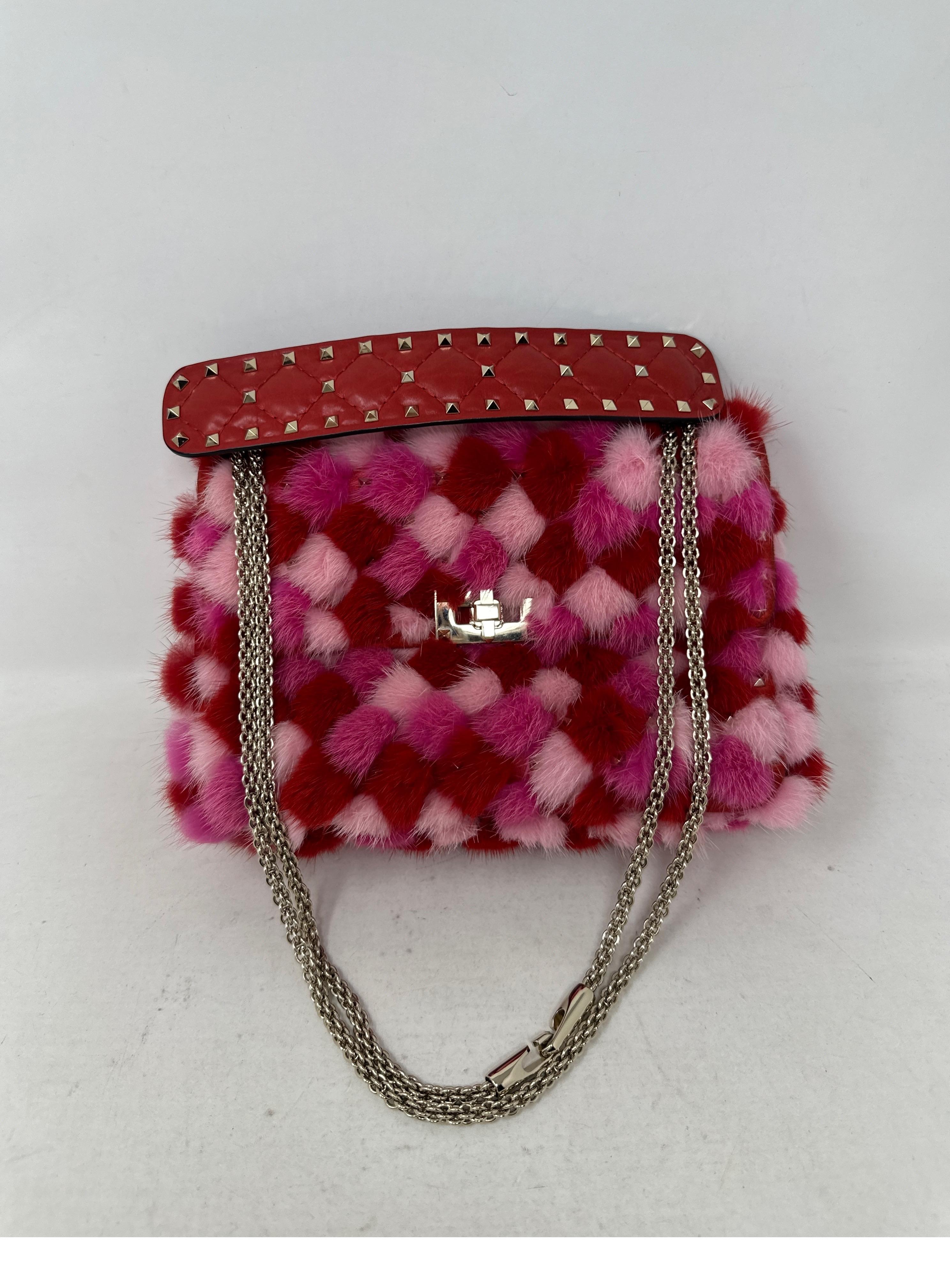 Valentino Multi-color pink mink bag. Different pink and red shades of mink fur. Handle all leather with studs. Rare and limited bag. Was over $7500 plus tax. Soft yellow gold hardware. Bag can be worn as crossbody or top handle bag. Interior all red