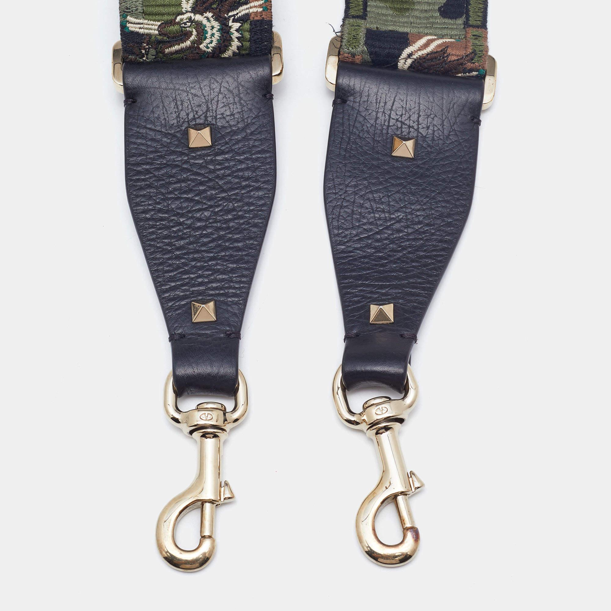Words fall short of describing this exquisite guitar bag strap from Valentino! Crafted with love from fabric and leather, the strap flaunts their Camu design in an artistic way. The piece is adjustable, and it has two clasps to hold your bags or