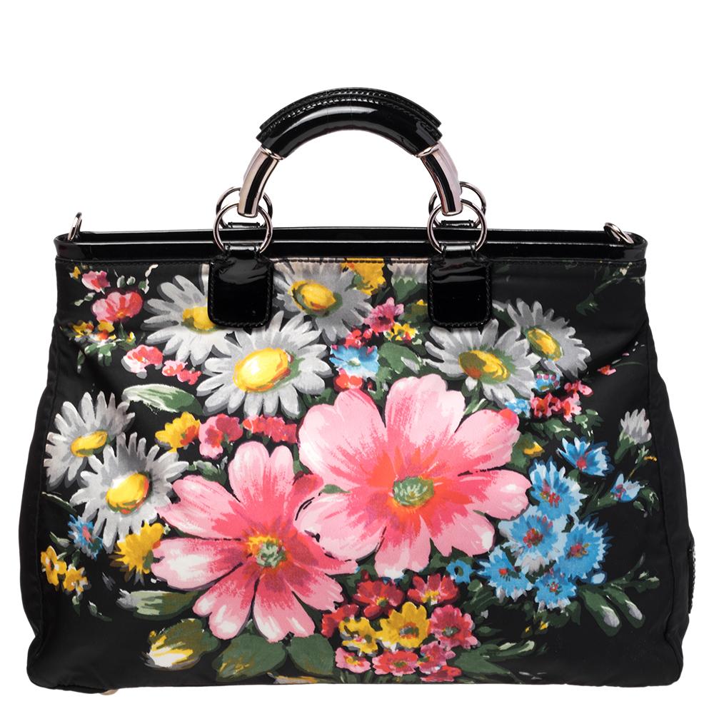 Set in a contemporary design and style, this tote from Valentino is absolutely mesmerizing. The lovely nylon tote features a beautiful floral print all over it. It comes with dual leather handles, a spacious satin-lined interior to house all your