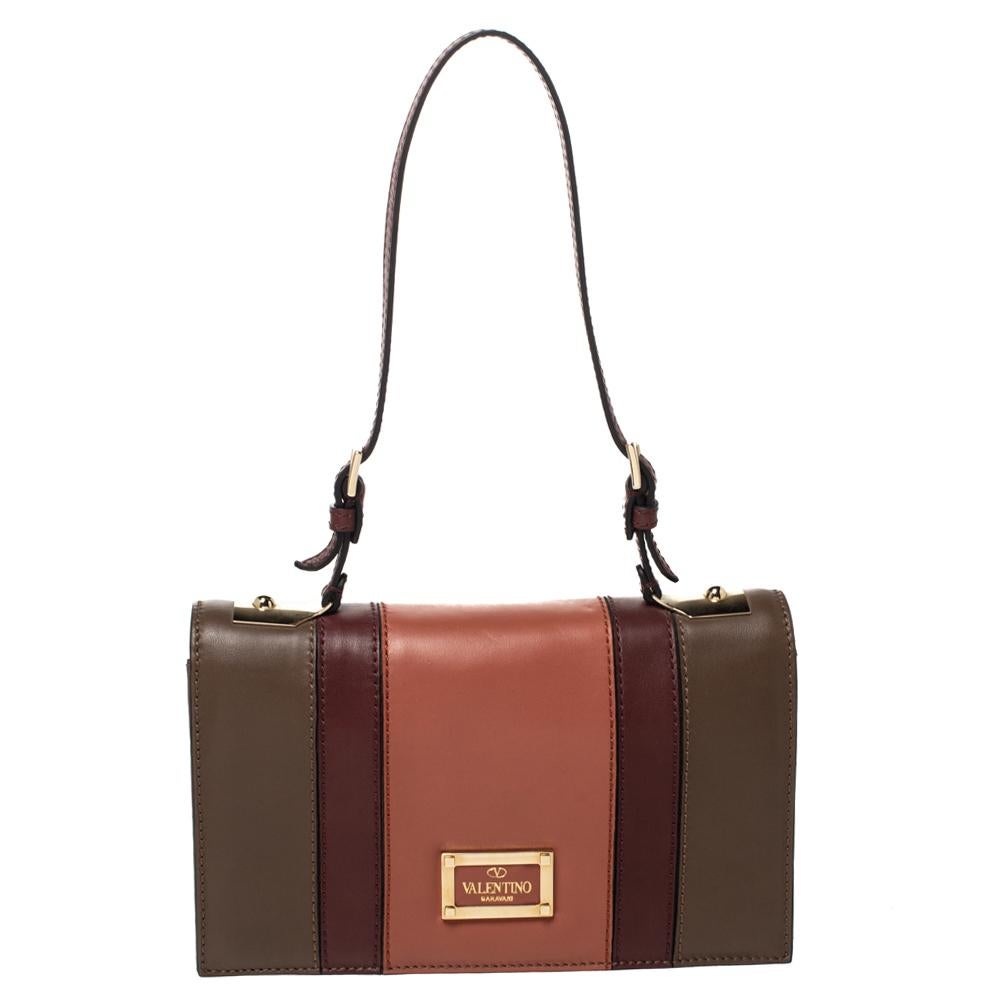 Now here's a bag that is both stylish and functional! Valentino brings us this gorgeous shoulder bag that has been crafted from colorblocked leather and designed with a flap that opens up to a canvas interior capable of carrying all your essentials.
