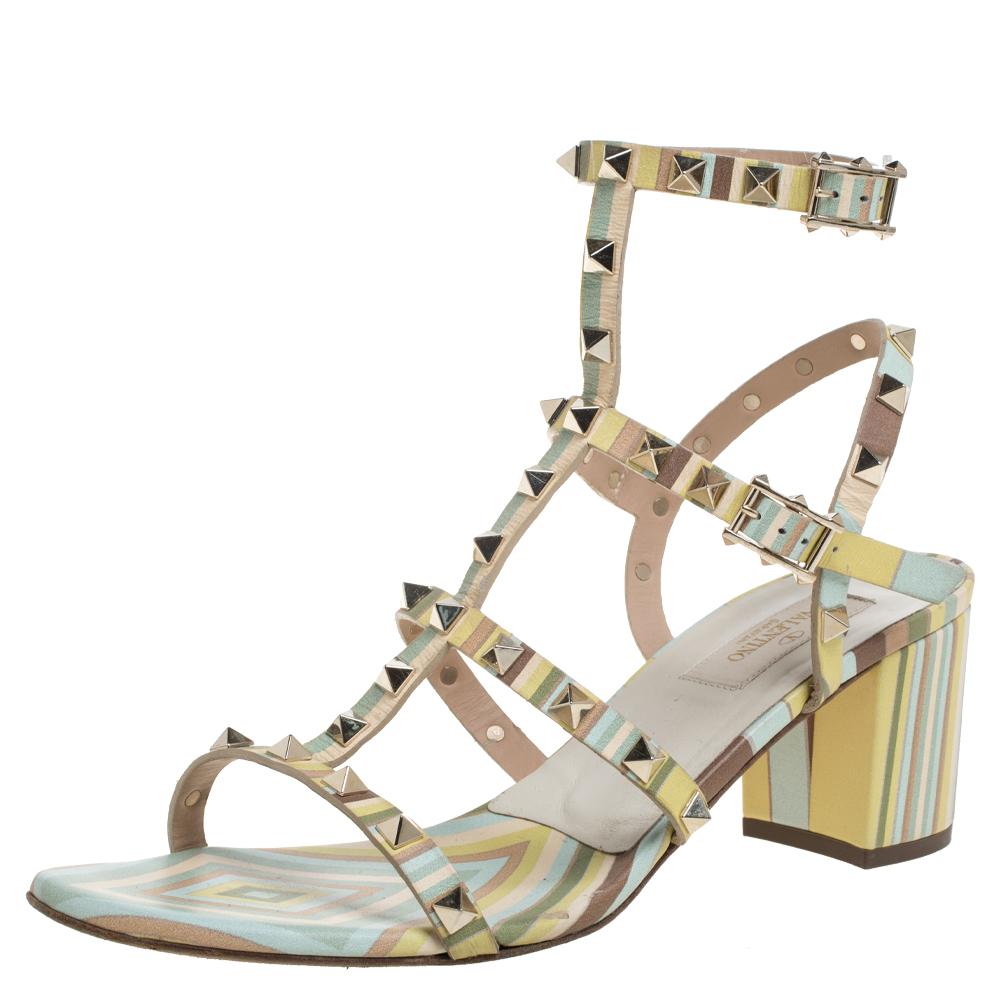 These sandals by Valentino have been designed to introduce your feet to the beauty of studs and embellishments. Framed in a caged manner using leather, the pair in multicolors has buckle closure around the ankle and block heels to grant you an