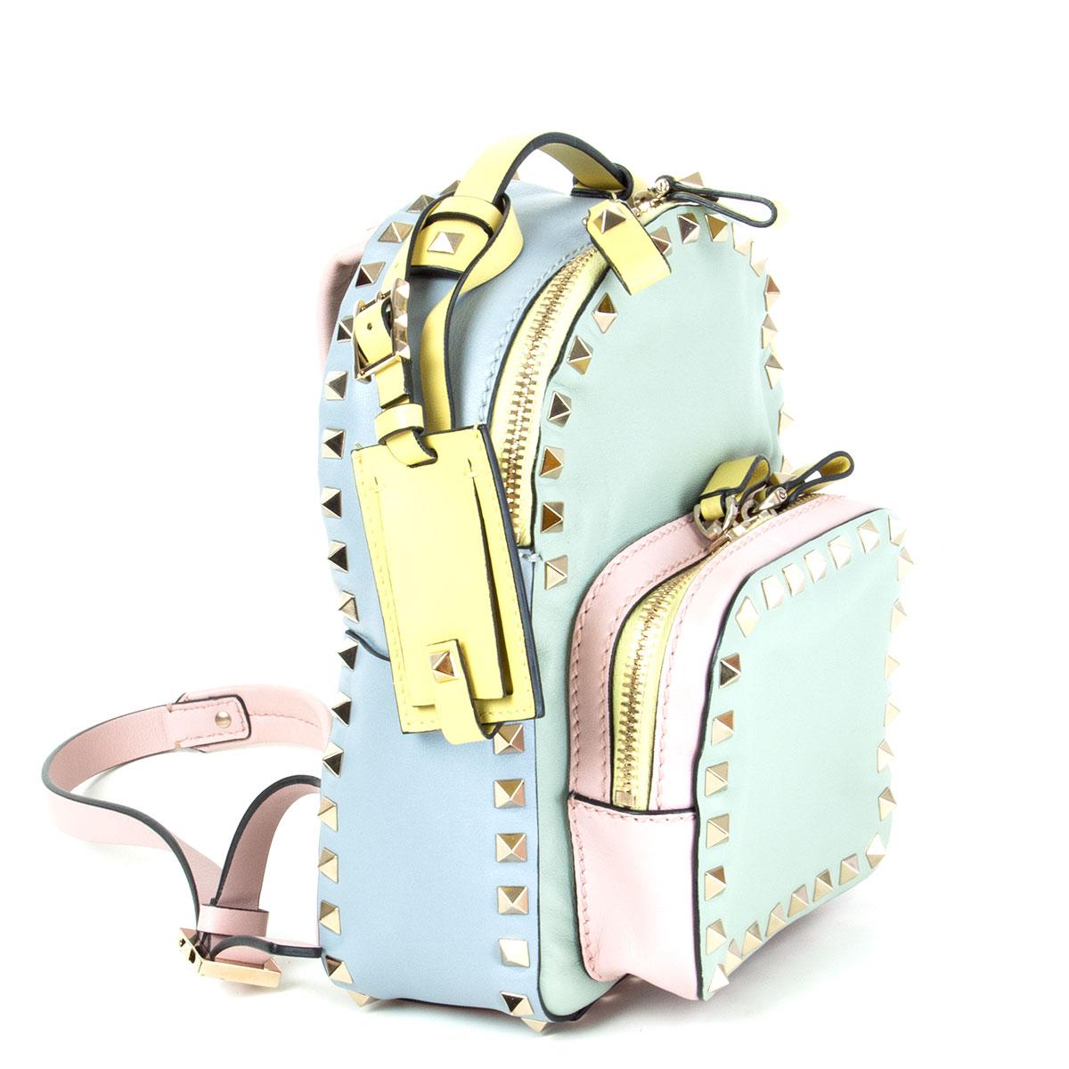 authentic Valentino Mini Rockstud Watercolor backpack in mint pastel, pink pastel, yellow pastel and blue pastel smooth lambskin featuring the signature light gold-tone pyramid studs. Has a zipped front pocket and two small slit pockets on the side.