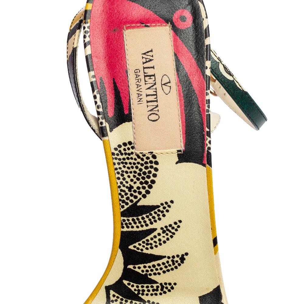 These sandals from the House of Valentino will let your feet appear stylish and chic! They are made using multicolored printed leather on the exterior and exhibit crisscross straps on the upper, an ankle-strap detail, and gold-toned hardware. They