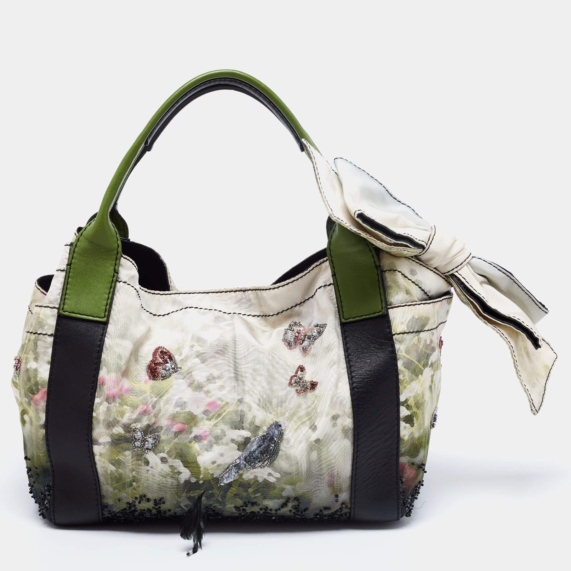 Get this lovely printed tote and carry it with style. This functional yet chic handbag by Valentino will surely meet all your expectations. It has two handles, a bow detail, side pockets, and a spacious interior for your belongings.

Includes:
