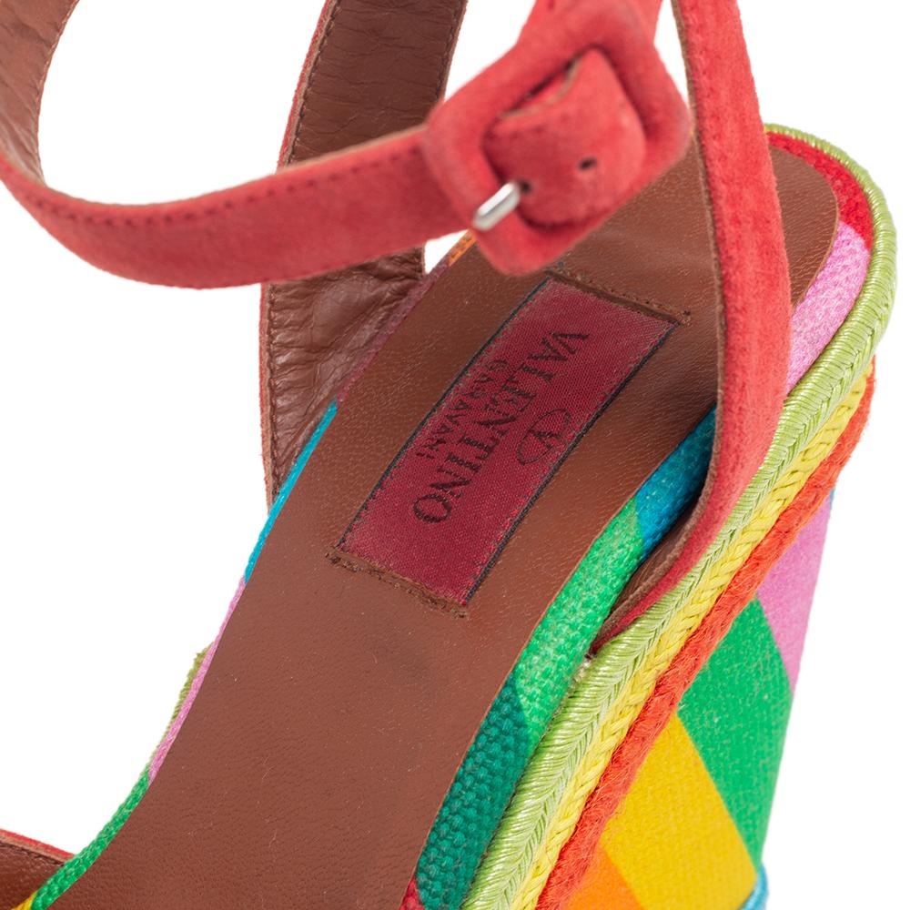Complete a day look with this pair of Valentino sandals. Constructed using suede, the open-toe sandals are secured with buckle closure at the ankles and lifted on colorful wedge heels.