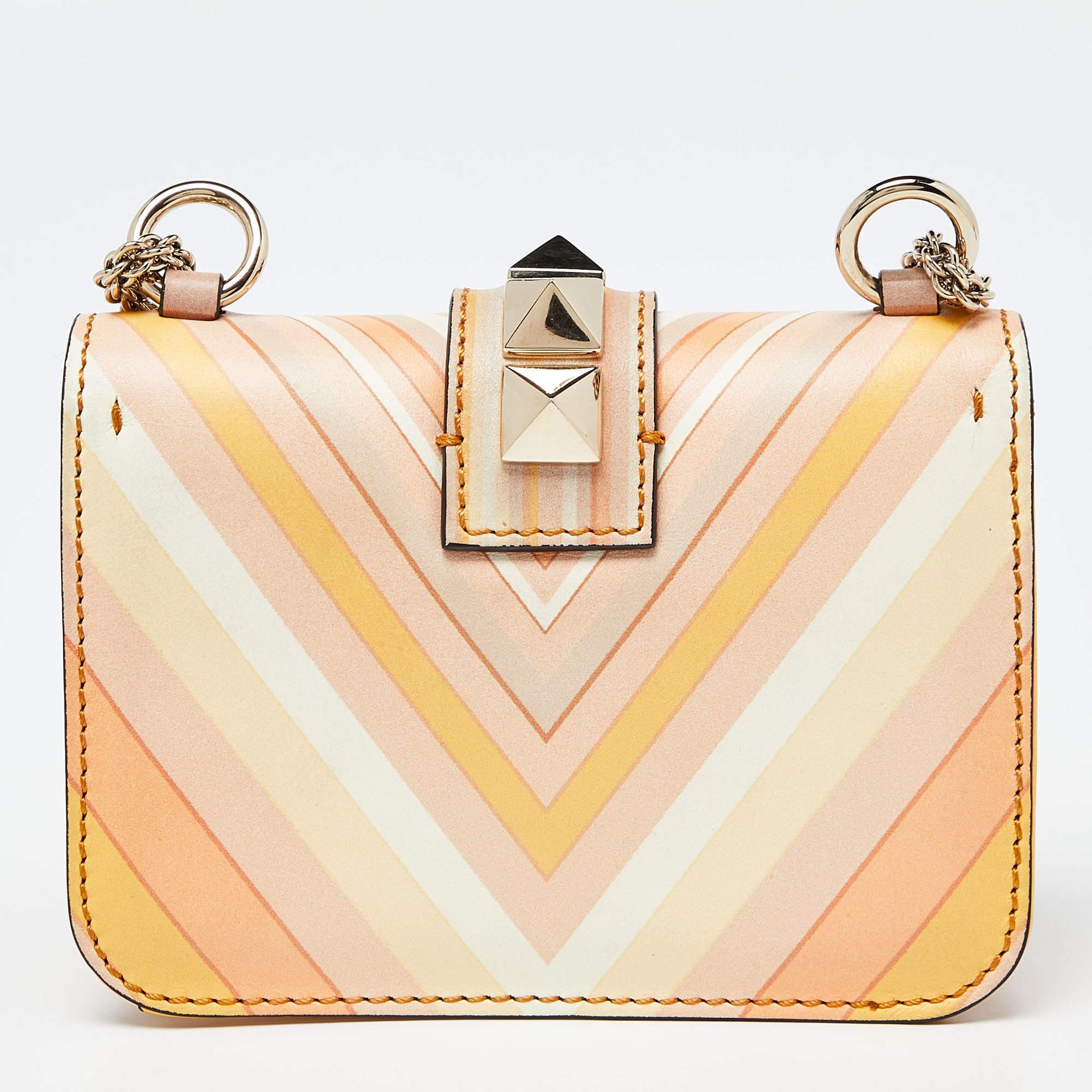 If you are looking for a bag with a blend of modern style and class, this Valentino creation is the answer. Crafted from leather, this multicolor piece comes with a gold-tone chain and a flap with a push-lock to secure the well-sized leather