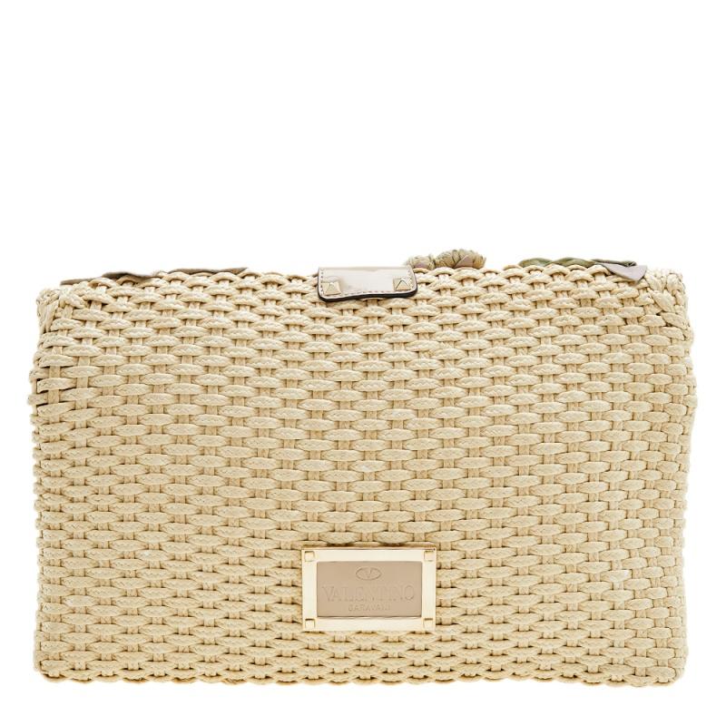 How gorgeous is this Valentino clutch bag made from woven raffia and leather! The multicolored creation displays amazing flower appliques on the front, with the flap opening into a well-sized satin interior to house your essential items.

Includes: