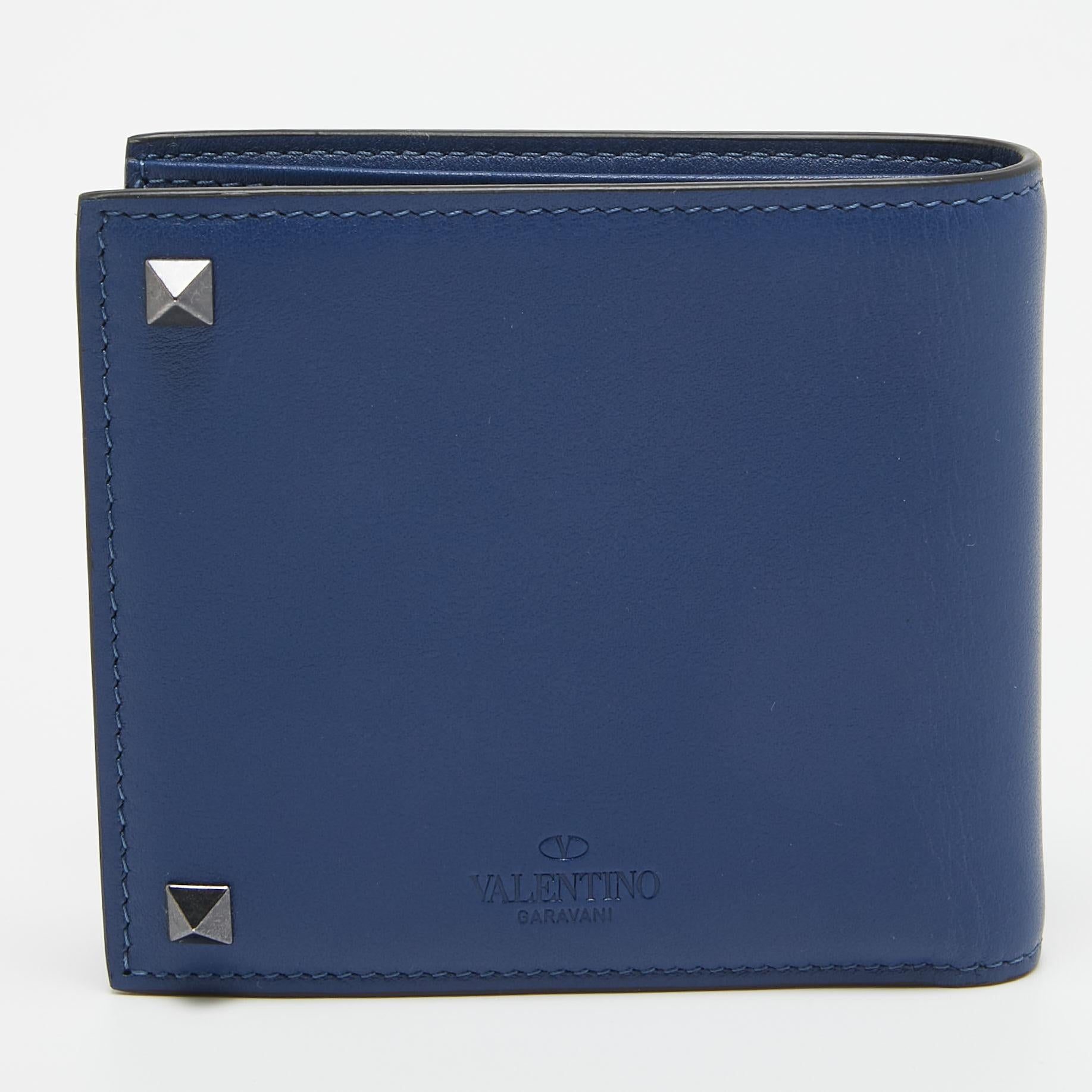 Valentino's Rockstuds takes inspiration from the frames of Roman doors; a signature detail that adorns this navy blue wallet. Made in Italy from leather that ages beautifully, it's crafted with a press-stud fastening that opens to reveal card slots