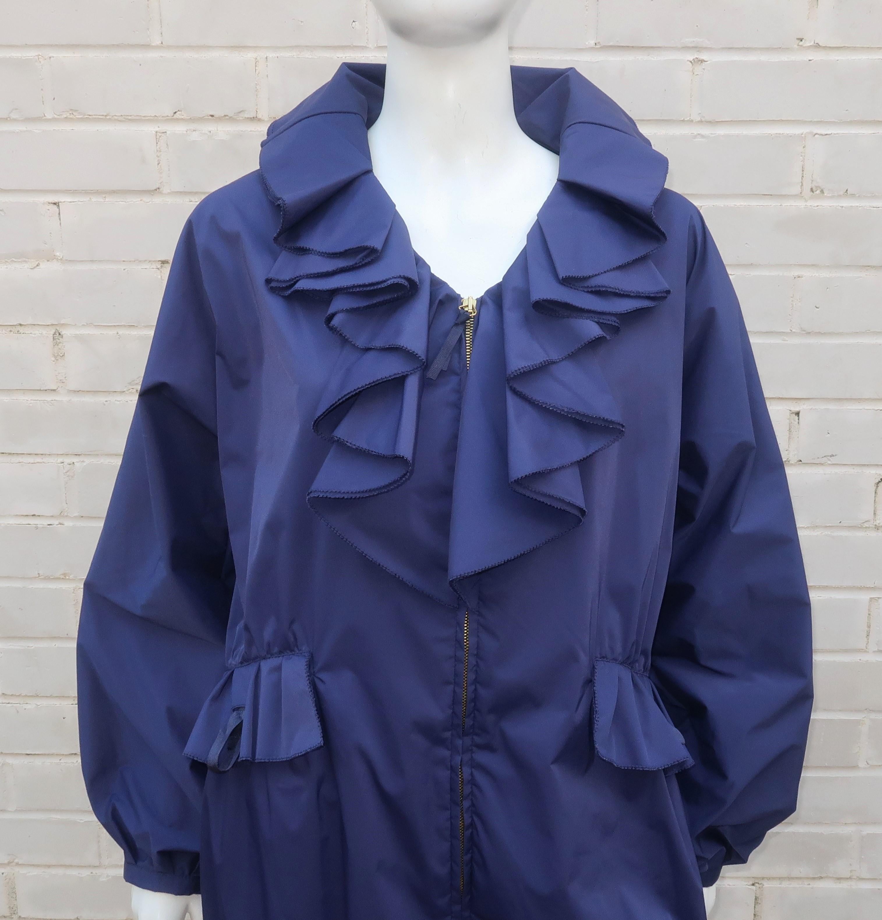 Valentino Roma navy blue windbreaker style jacket with ultra feminine details including a ruffled collar and bubble silhouette.  The jacket has a double zipper at the front, snaps at the hemline, modified balloon sleeves and unique pockets with