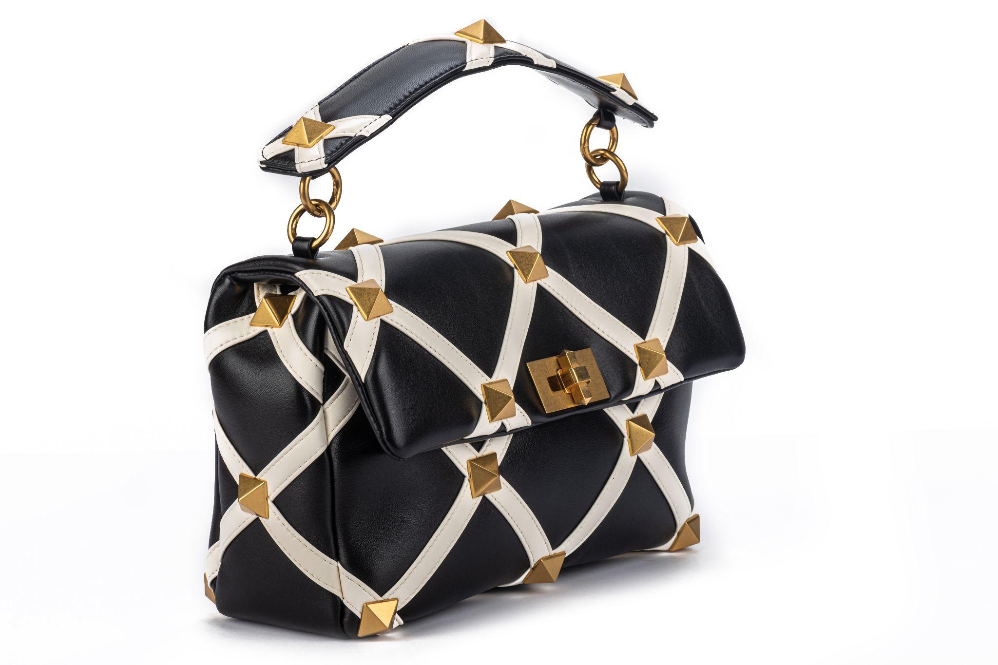 Valentino new black and white leather Roman stud large bag. Brushed gold studs. Can be worn 2 ways , both handle and chain strap are detachable. Handle drop 3”, shoulder drop 25”. Comes with original tag, booklet and dust cover.