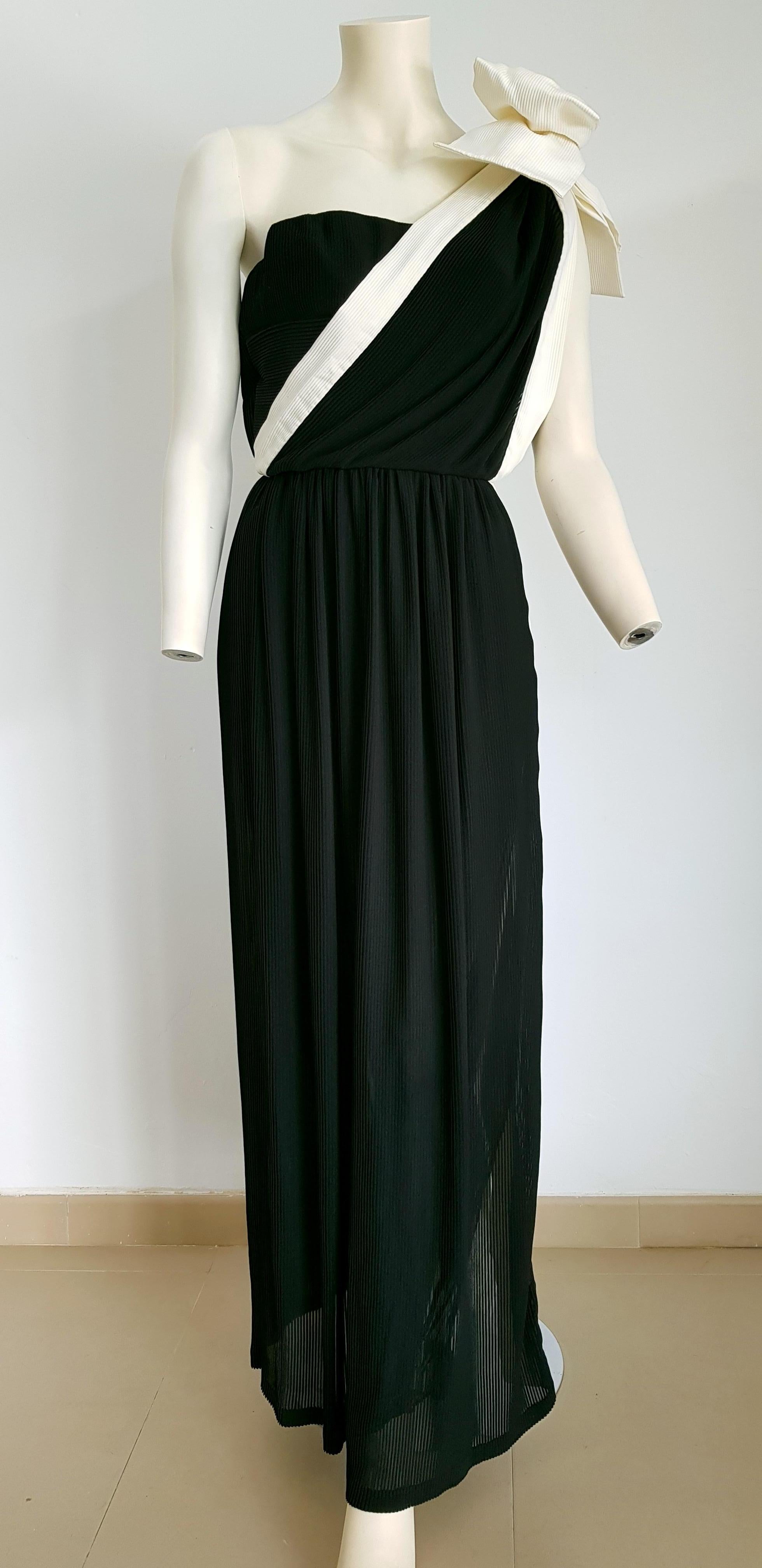 VALENTINO Haute Couture, one shoulder strap with white bow, vertical white left side stripe, pleated black silk dress gown - Unworn, New.

By 