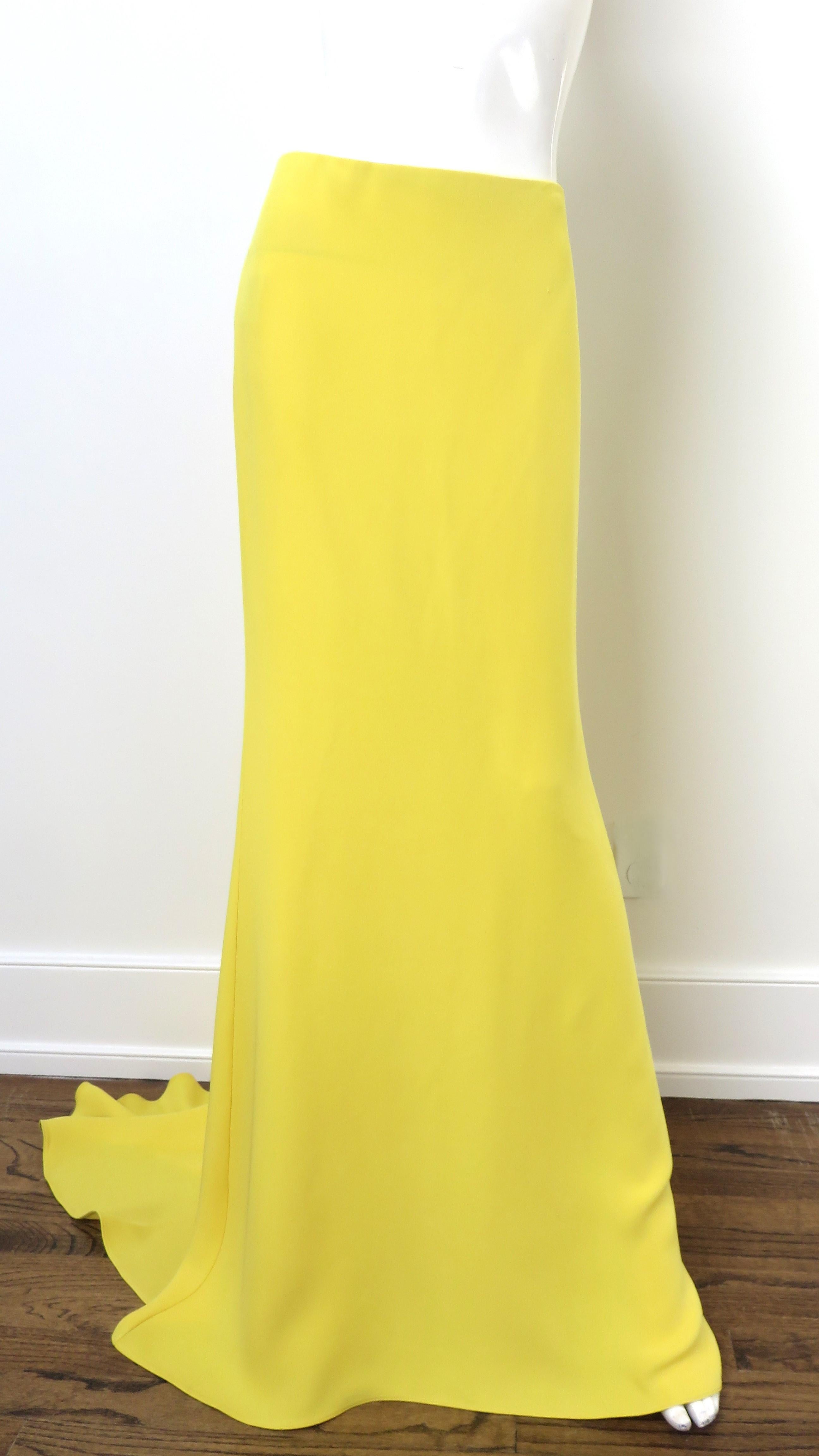 A stunning yellow silk skirt from Valentino.  It is floor length with a train, cut on the bias for a great, flexible fit and has a back zipper.
Fits sizes Small, Medium.  Marked Italian size 40.

Waist  28