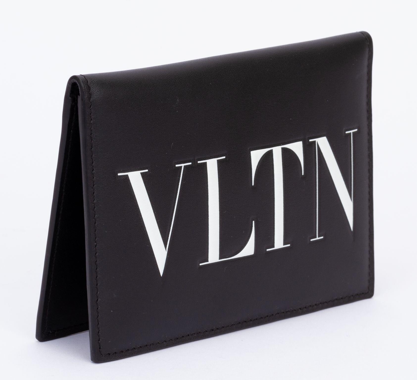 Valentino passport cover with several card holders and a zippered pocket inside. On the outside the Valentino is written on it in white. The piece is brand new and comes with the tag, original box and dust cover.