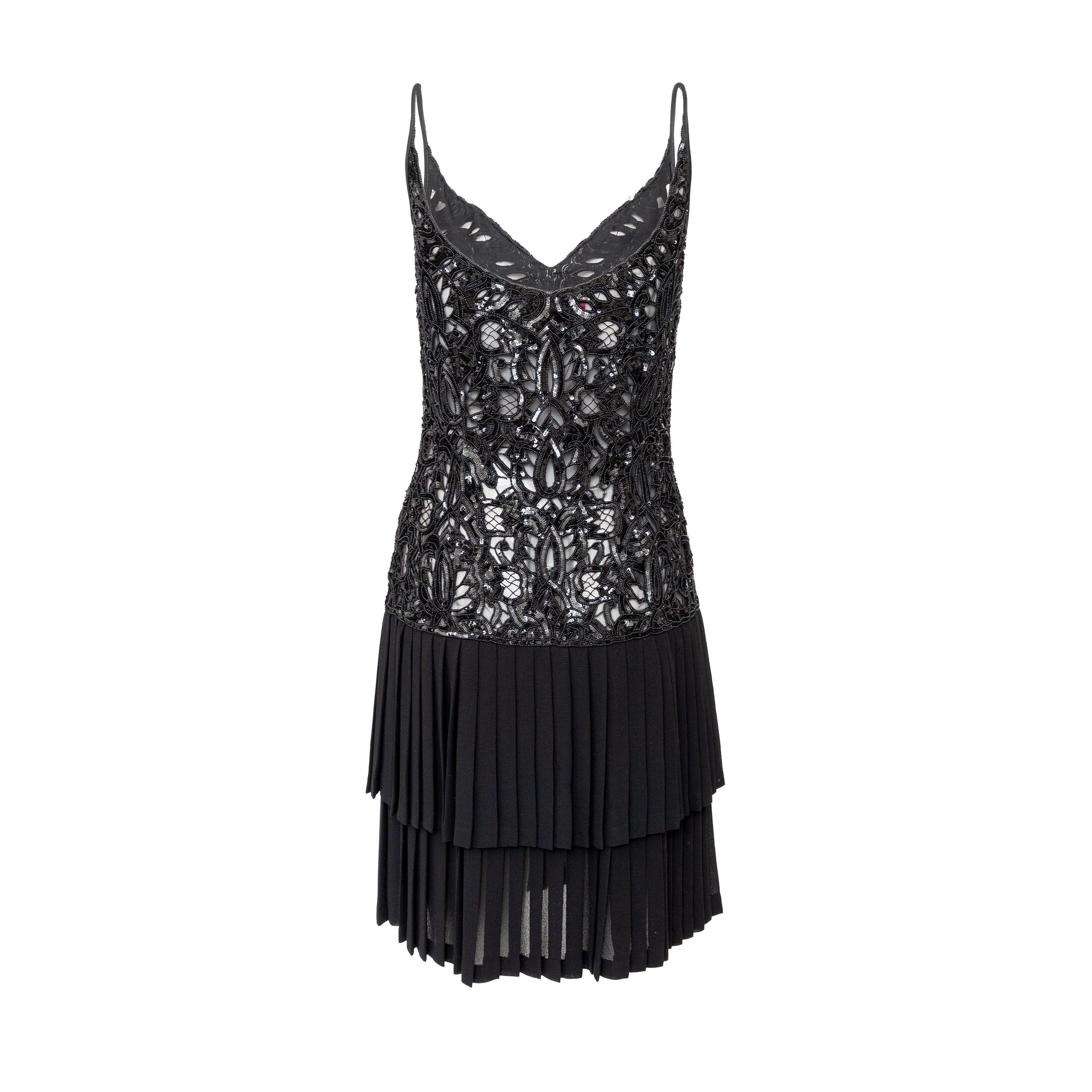 Effortlessly elegant, the Valentino Night Beaded Dress from the 90s collection features delicate sequin and bead detailing on the upper and a heavy silk viscose blend fabric with layered accordion pleats on the lower portion. With a v-neck and thin