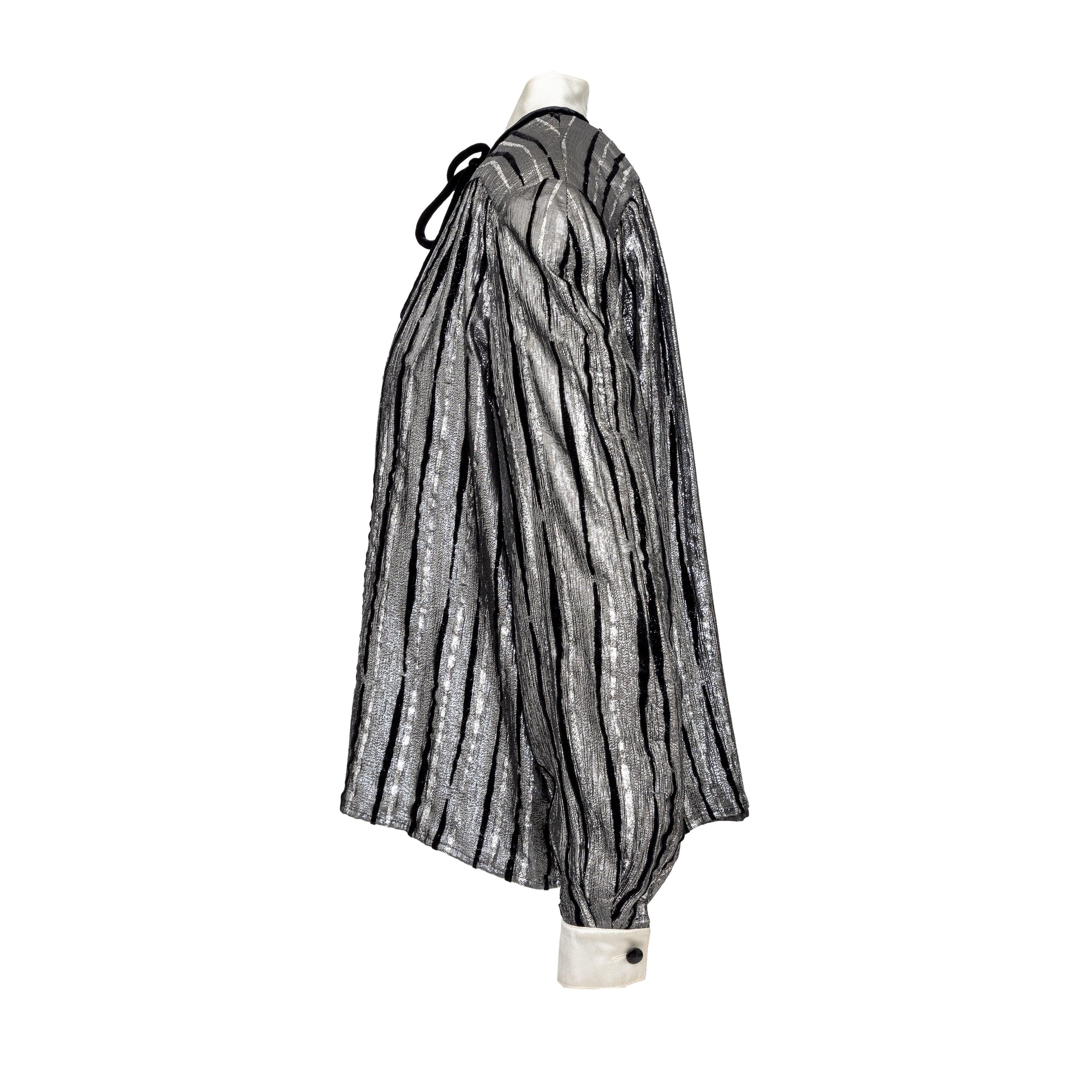 Introducing the Valentino Night shirt from the 90s. Made from silk with silver and black stripe pattern, this shirt from the Valentino 'Night' label is both luxurious and eye-catching. Its soft silhouette is enhanced by velvet tie-knot at the collar